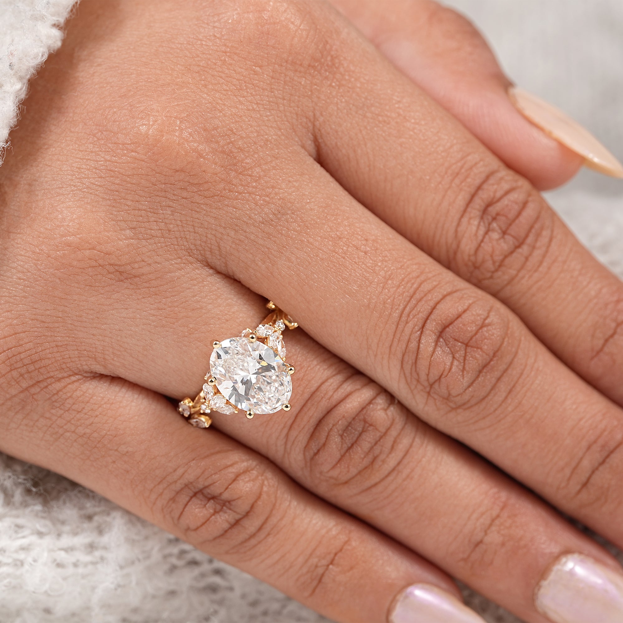 Elegant oval cut diamond ring with floral vine detailing and hidden halo sparkle