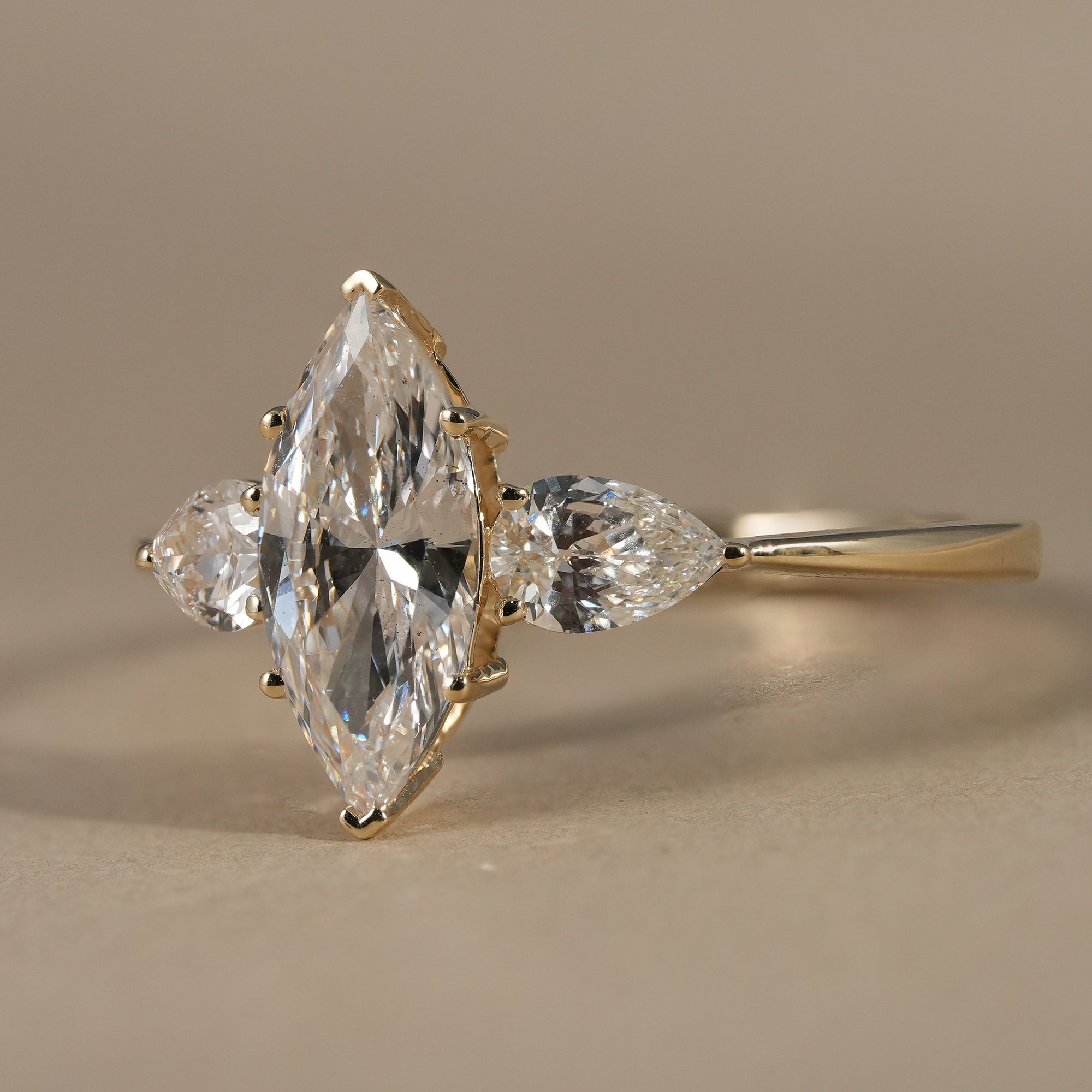 Three Stone Marquise Cut Lab Diamond Engagement Ring With Pear Side Stones