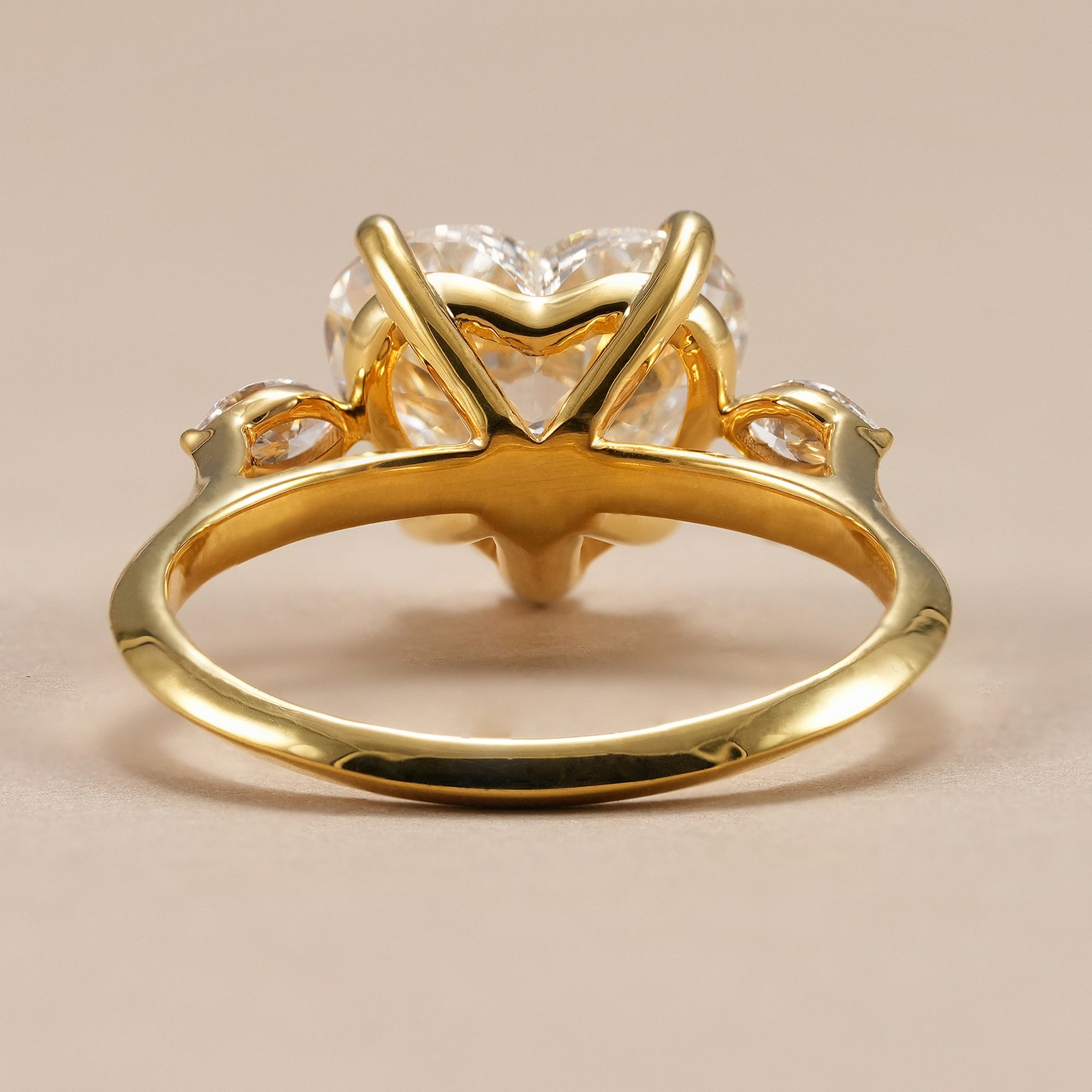 Heart cut diamond proposal ring with elegant three stone setting.
