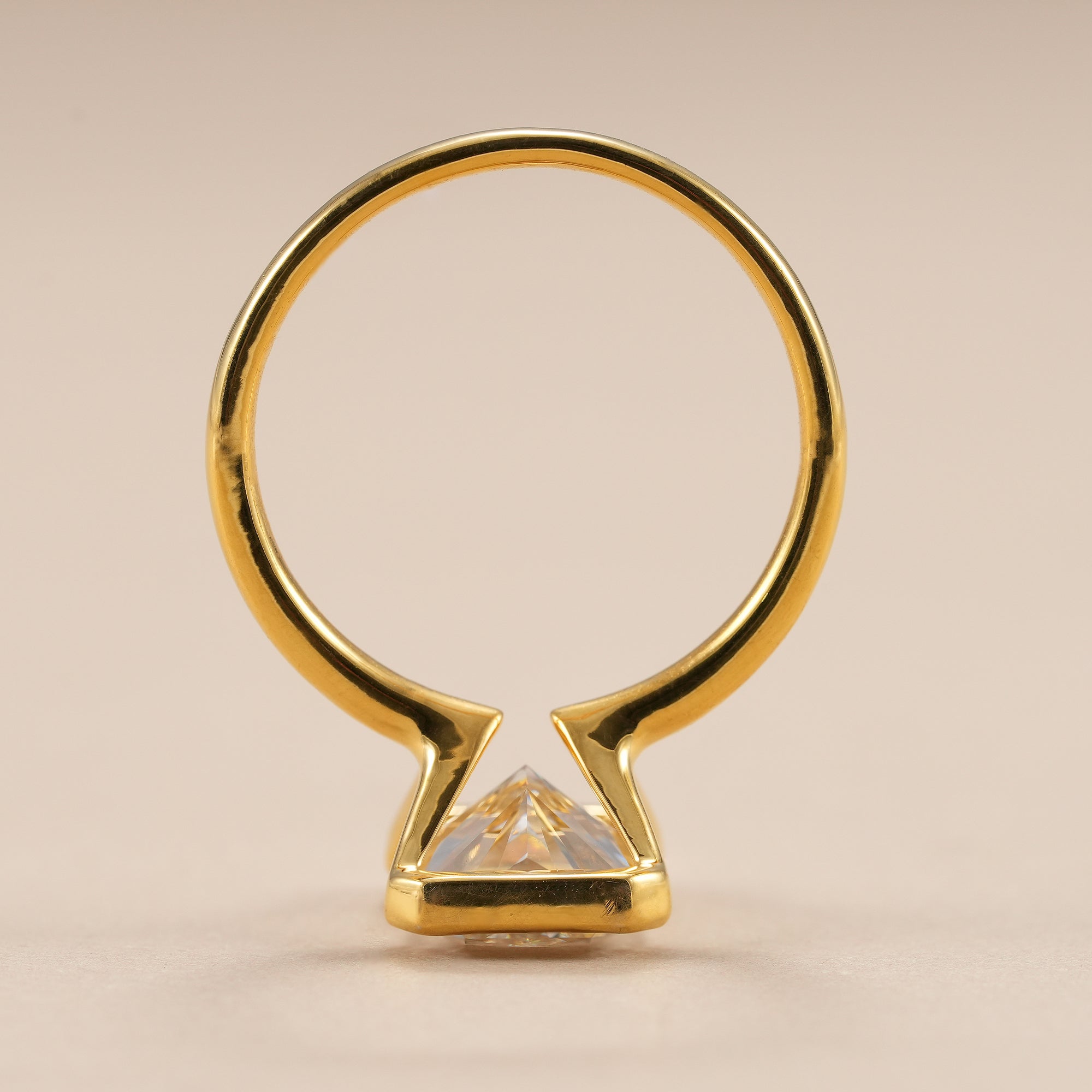 Luxury radiant lab diamond engagement ring with sleek bezel design.