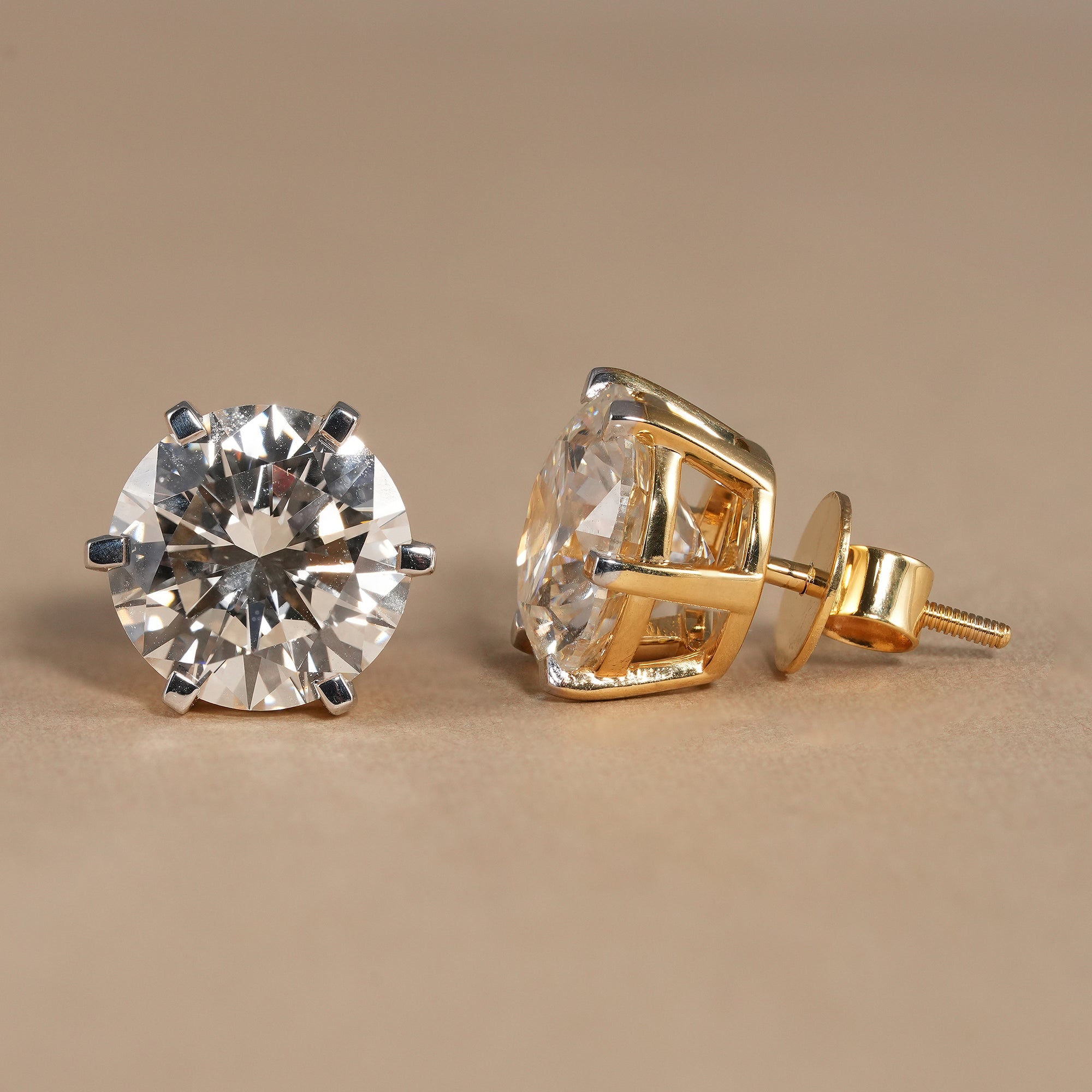 Elegant round solitaire diamond stud earrings handcrafted in yellow gold with six prong design