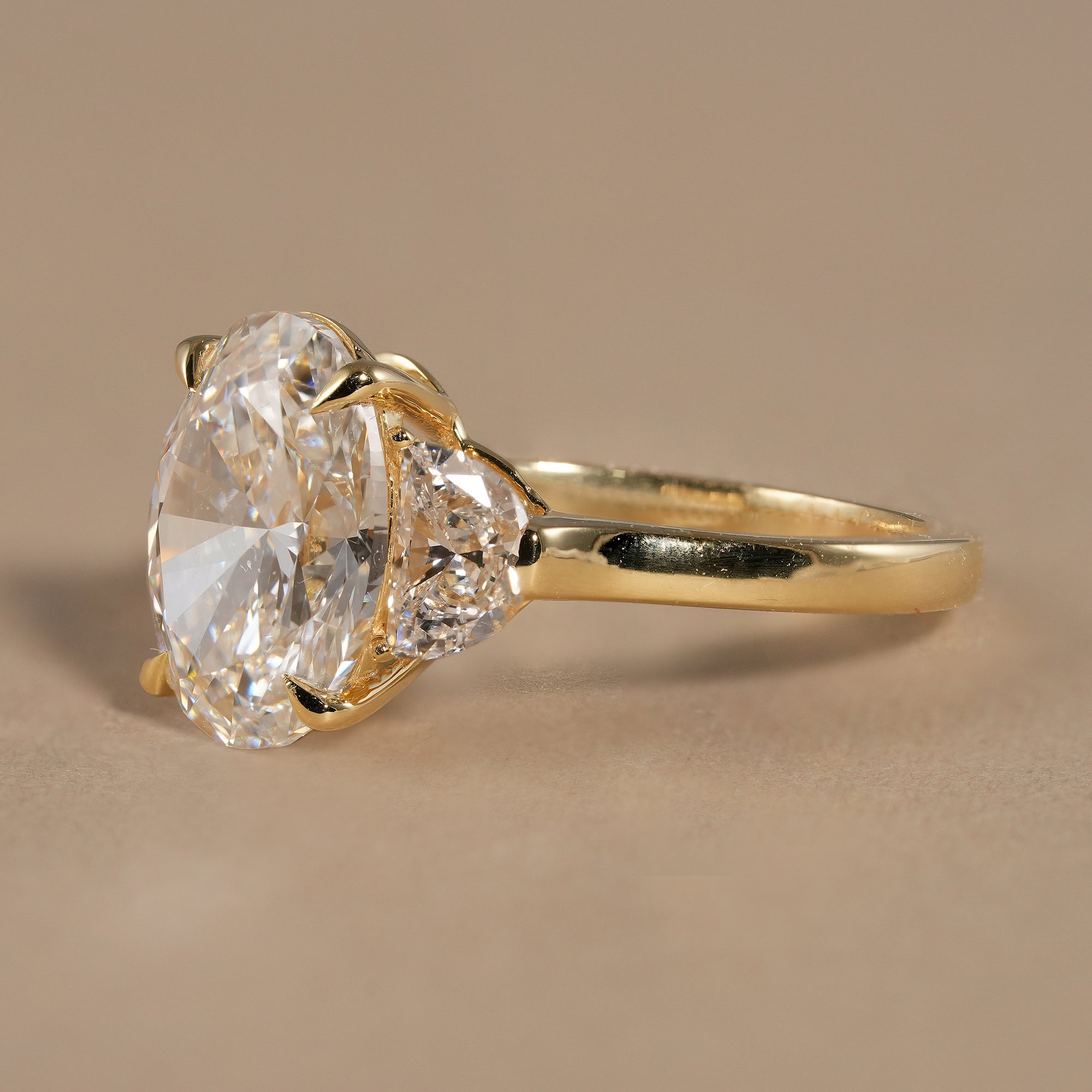 Elegant oval trilogy engagement ring handcrafted with IGI certified lab grown diamonds