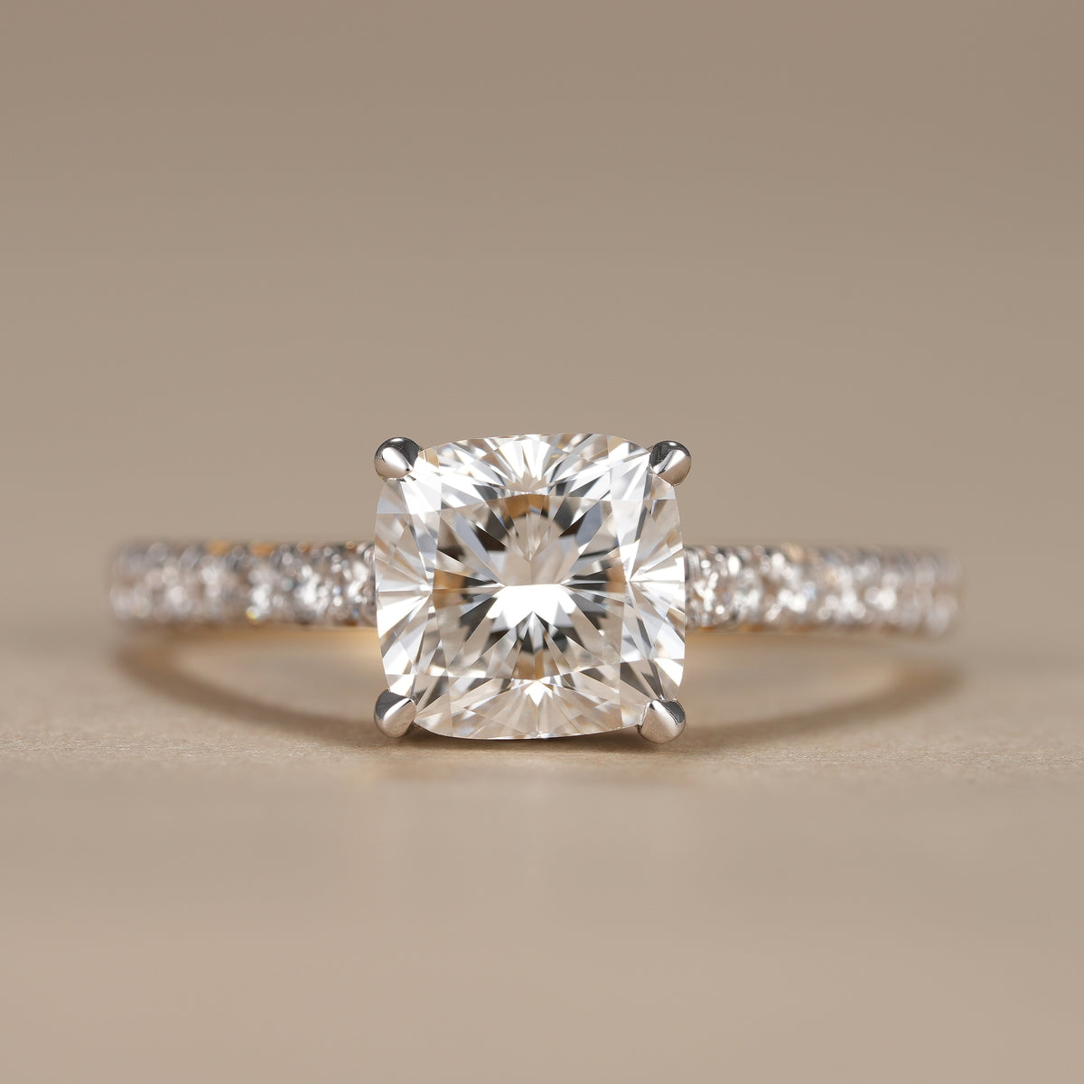 3 CT cushion lab grown diamond hidden halo engagement ring with sparkling pavé band in solid gold.