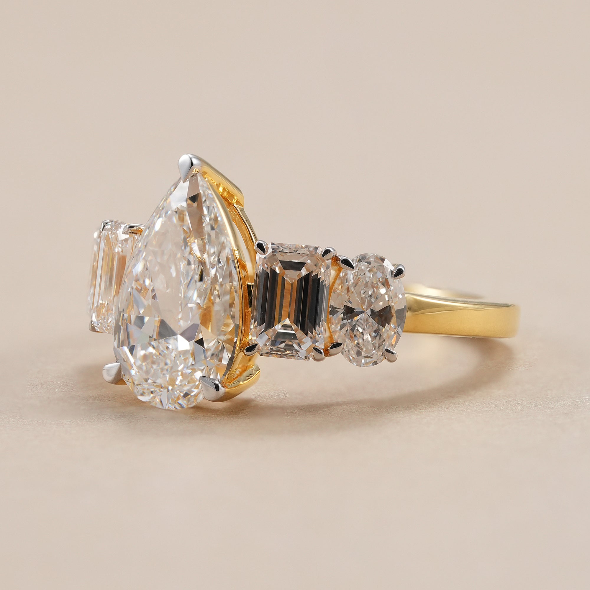 IGI certified 3 CT pear diamond engagement ring in yellow gold.