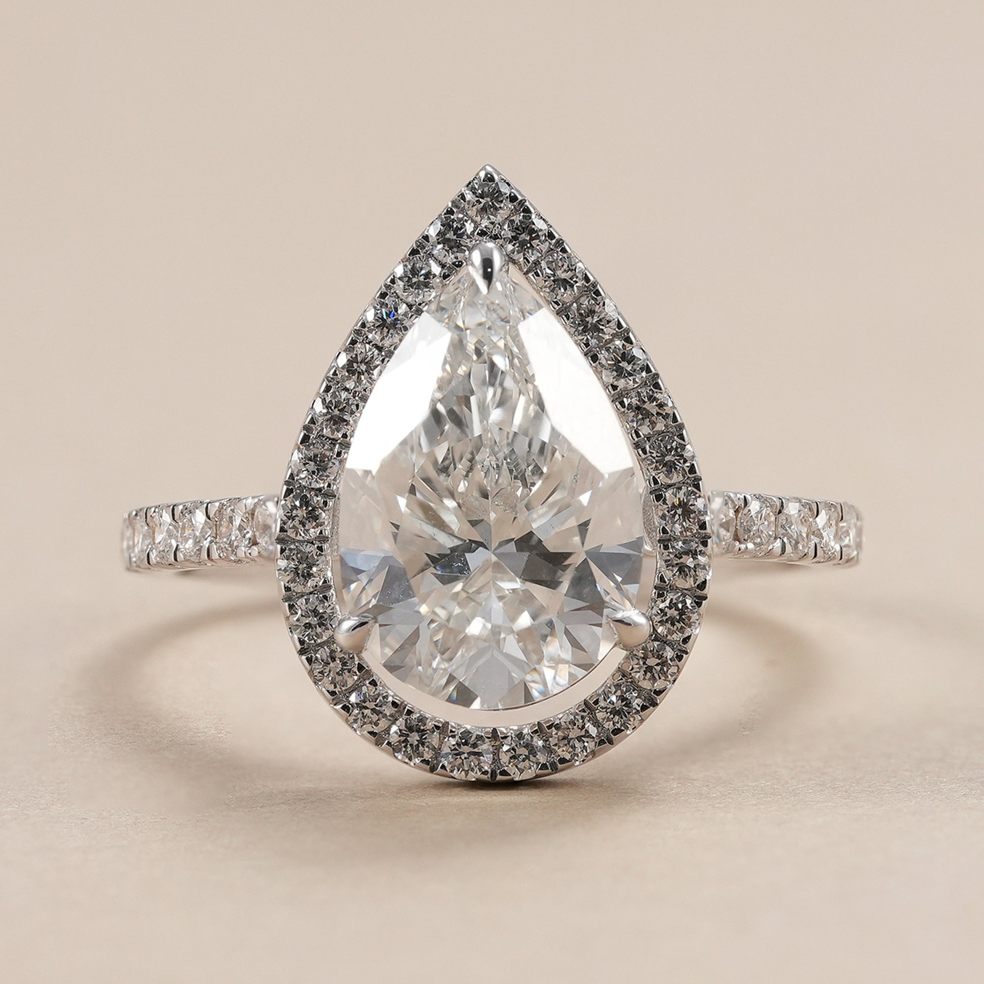3 CT pear lab grown diamond halo engagement ring with pave band.