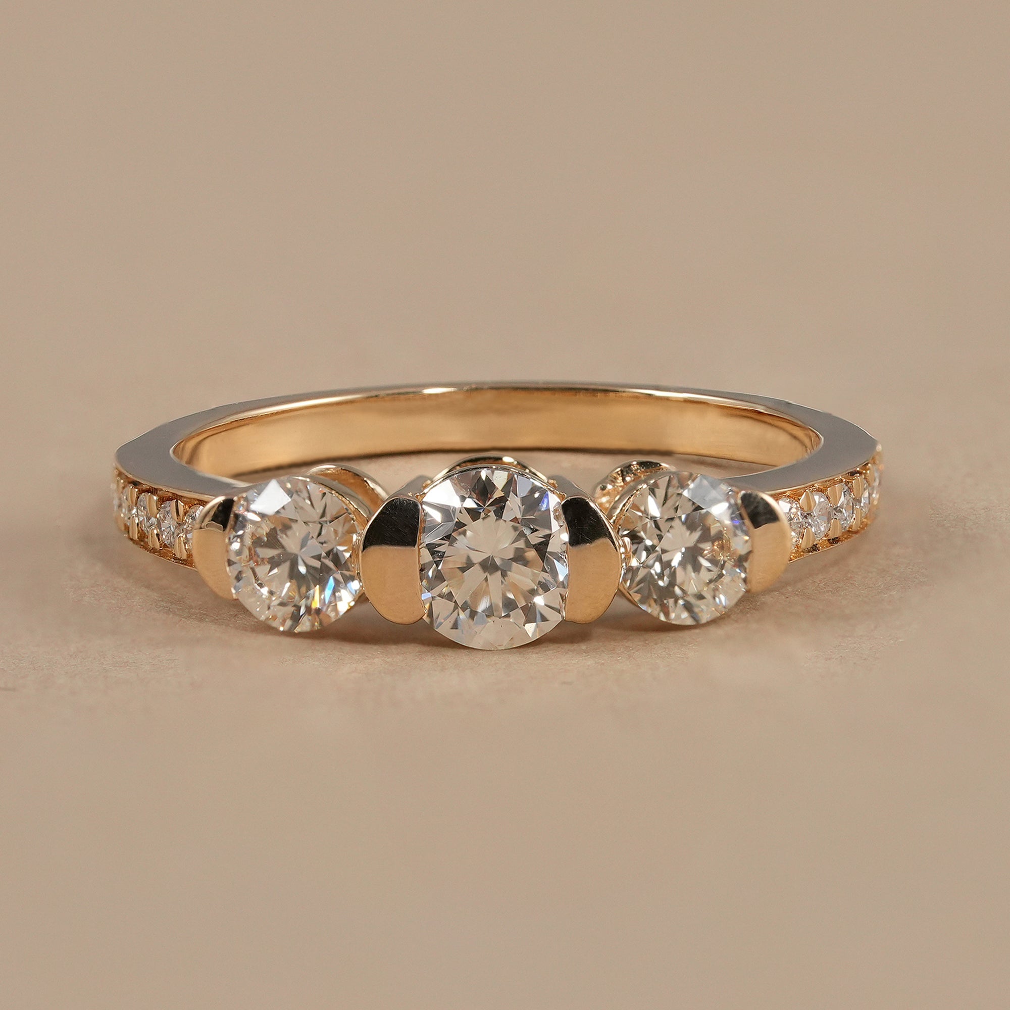Round three stone lab grown diamond engagement ring with sparkling pavé band
