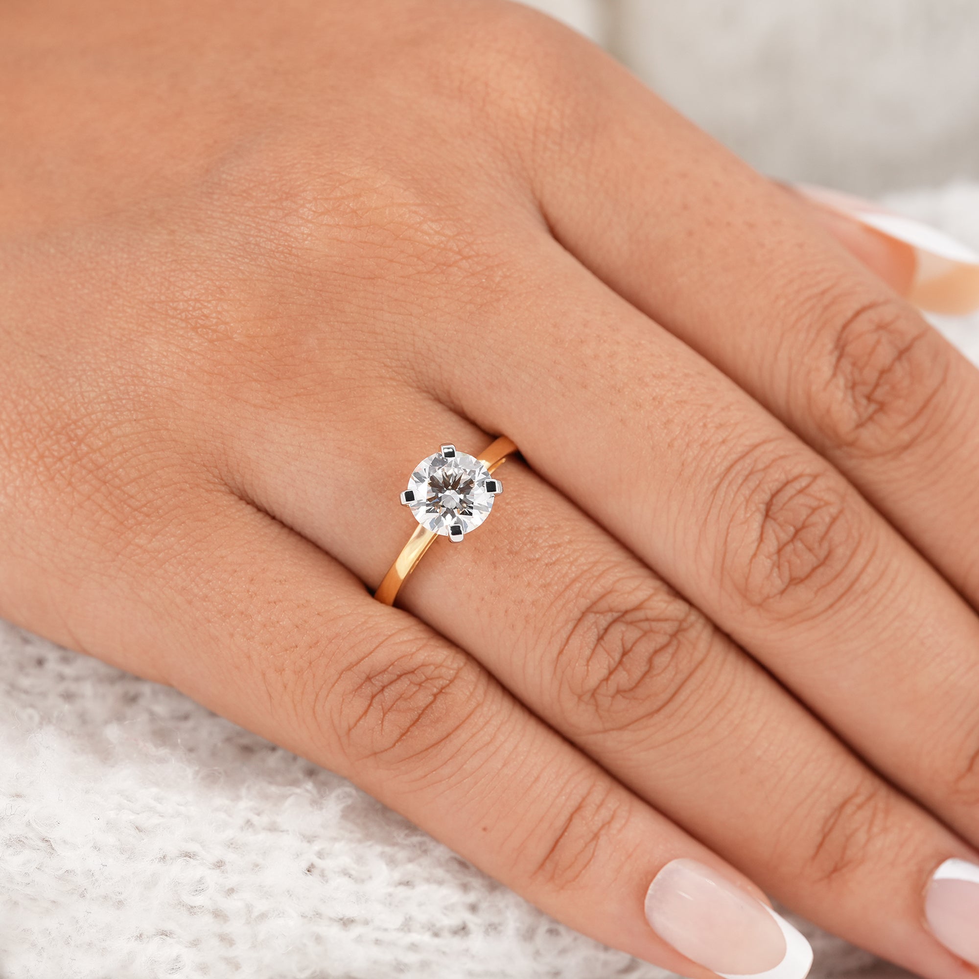 Round brilliant lab diamond solitaire ring with polished gold band