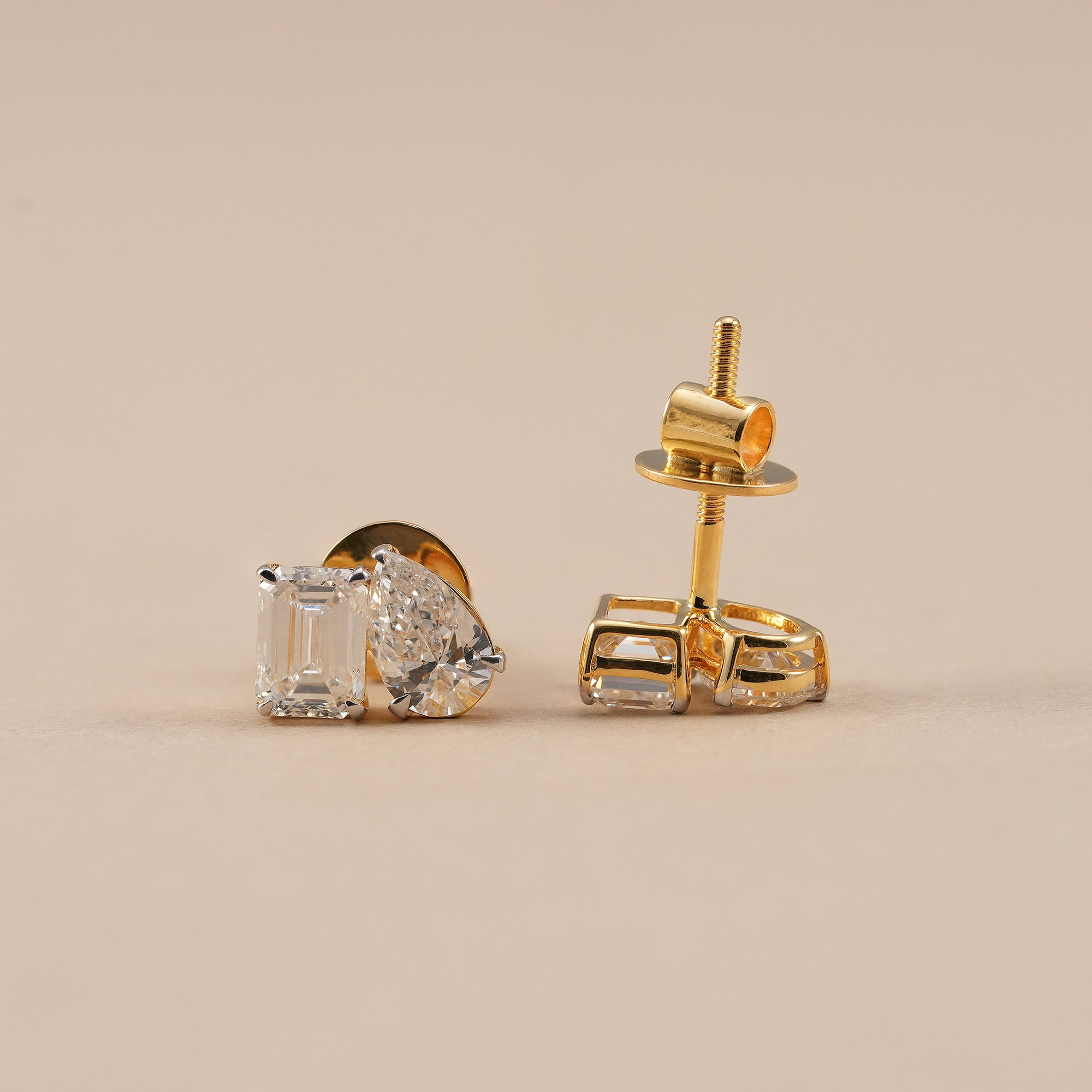 Modern emerald and pear diamond stud earrings for women