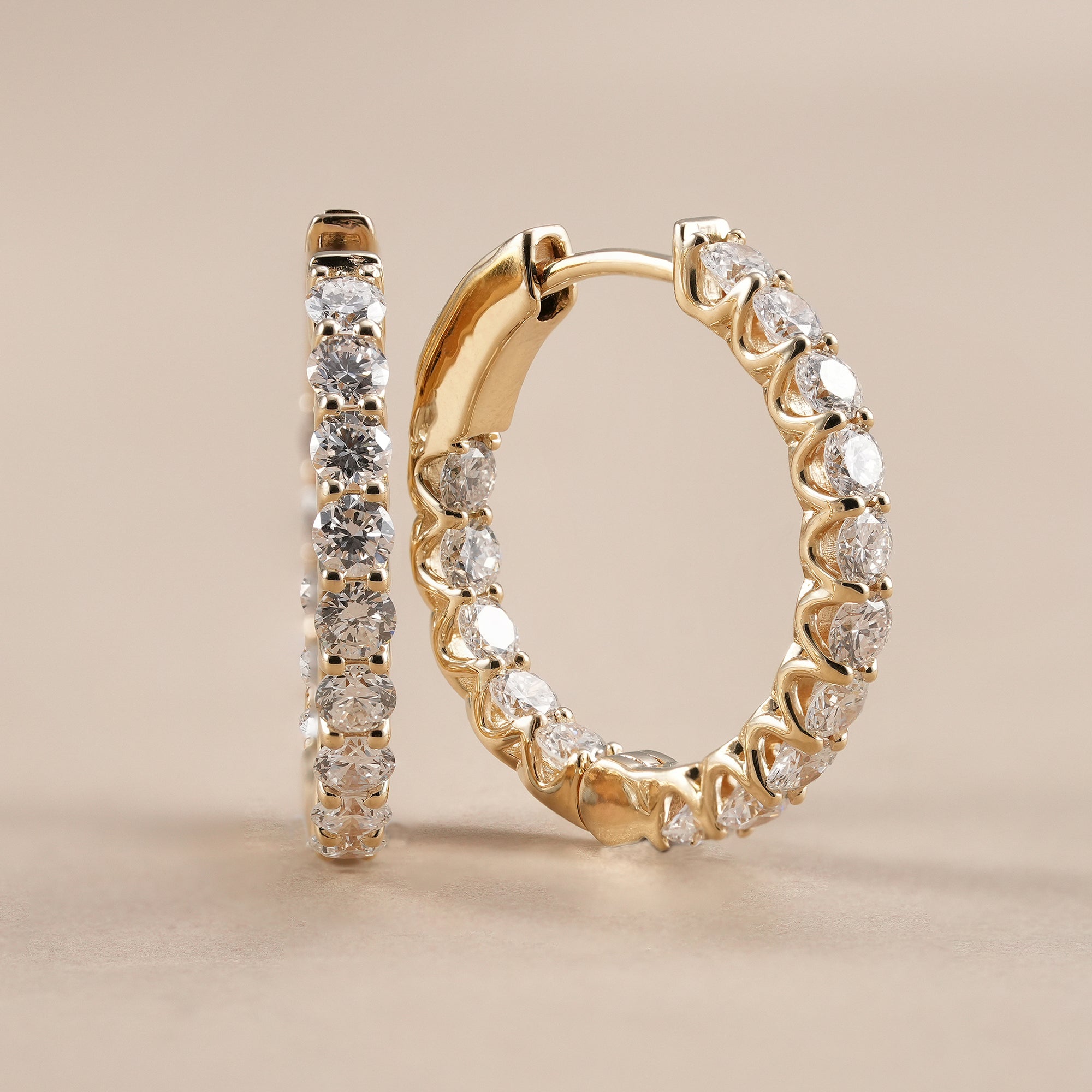Women's diamond huggie earrings handcrafted in solid gold for everyday elegance