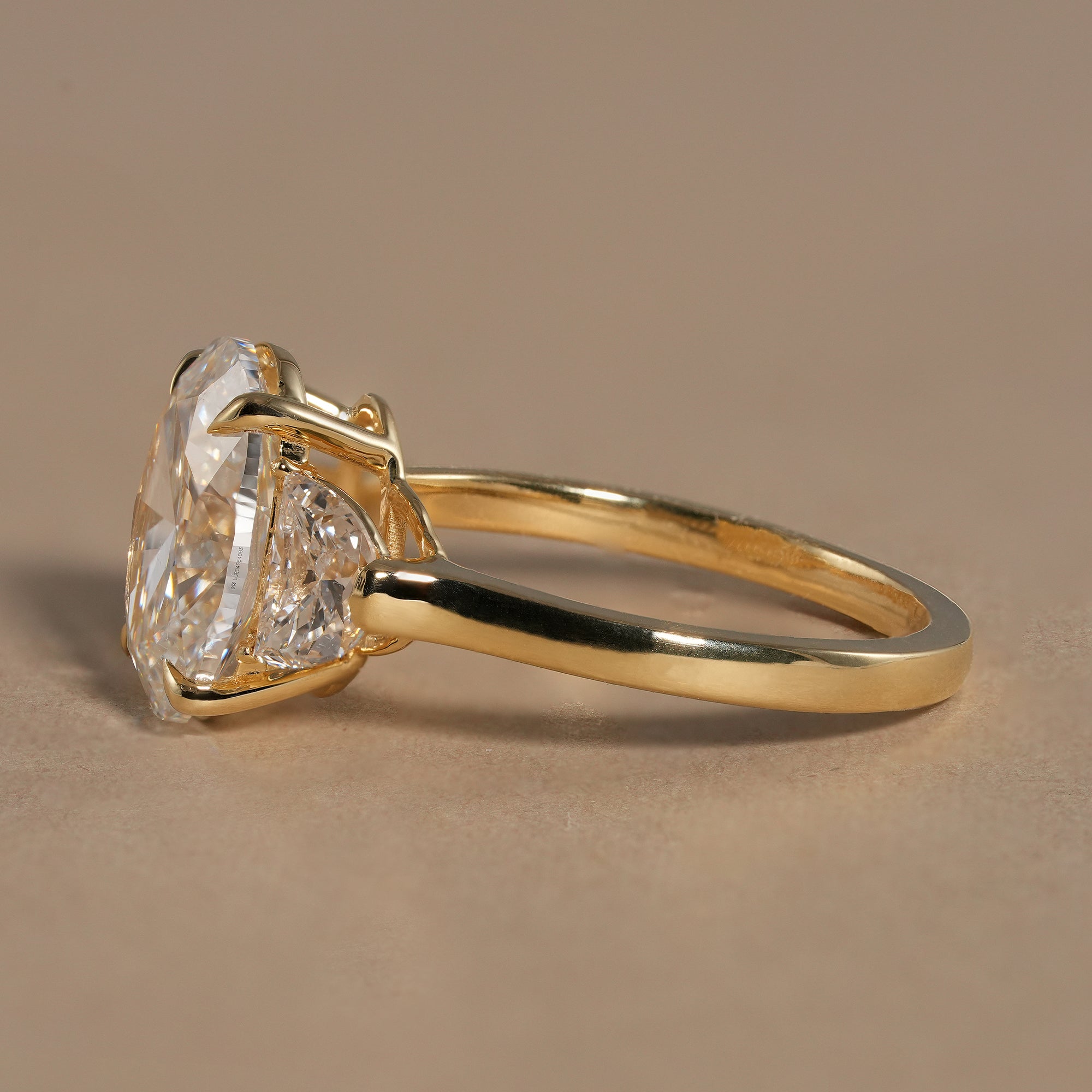 Luxury oval engagement ring featuring three stone past present future design