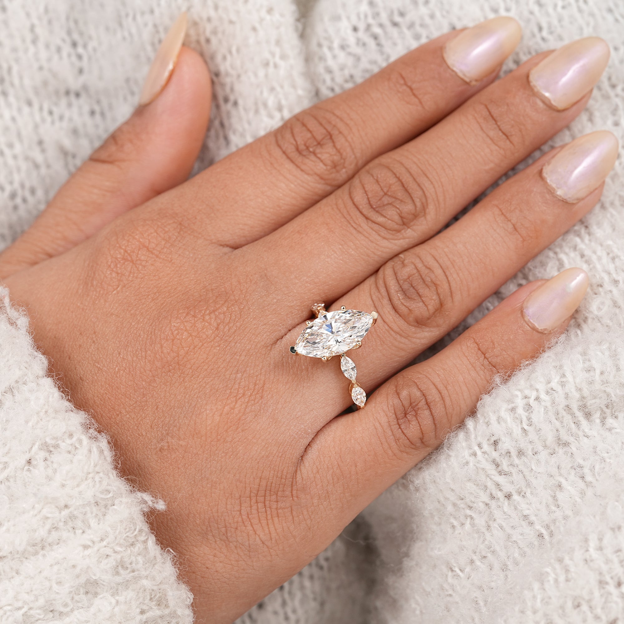 Yellow gold marquise engagement ring with leaf inspired diamond accents