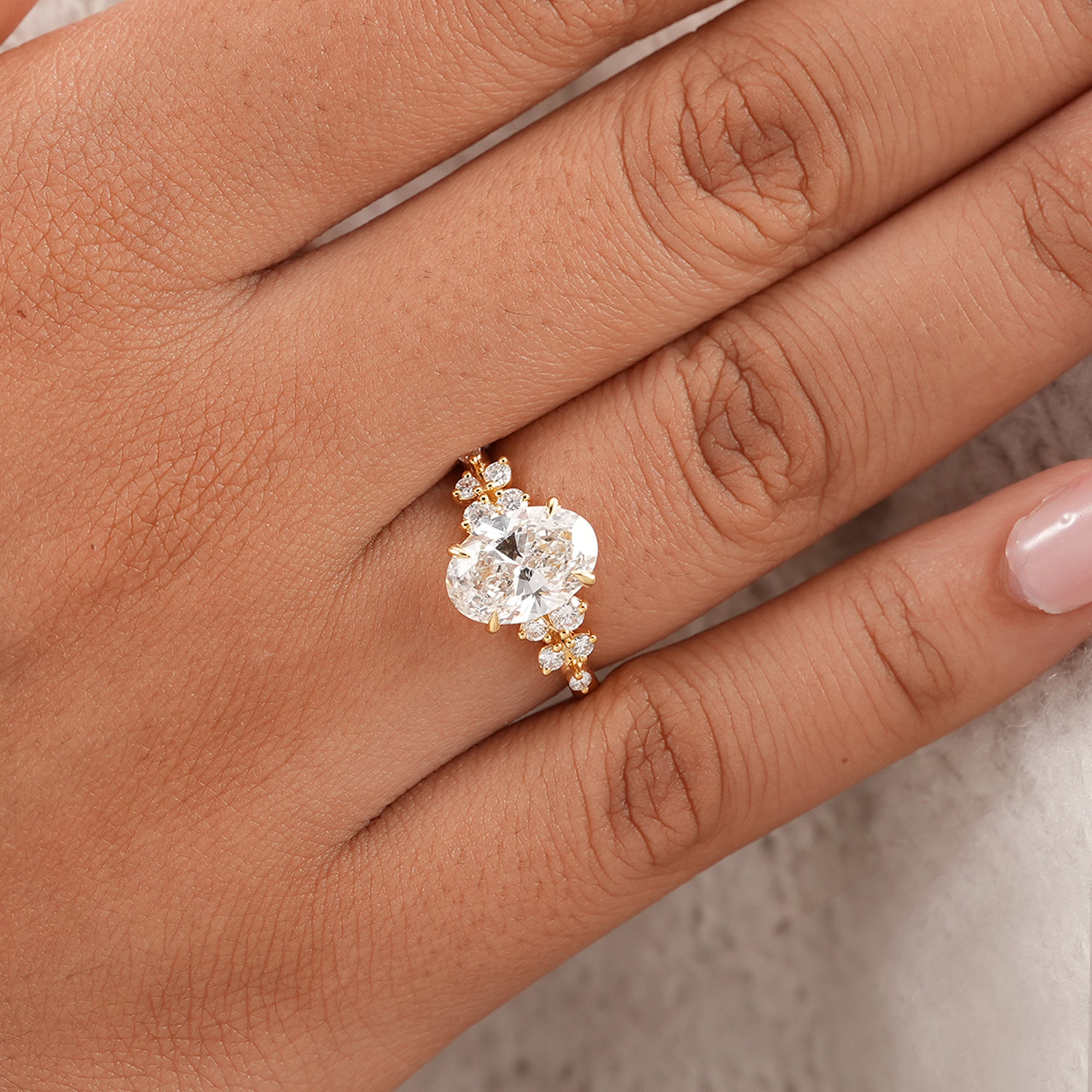 Nature inspired oval diamond wedding ring with floral accents