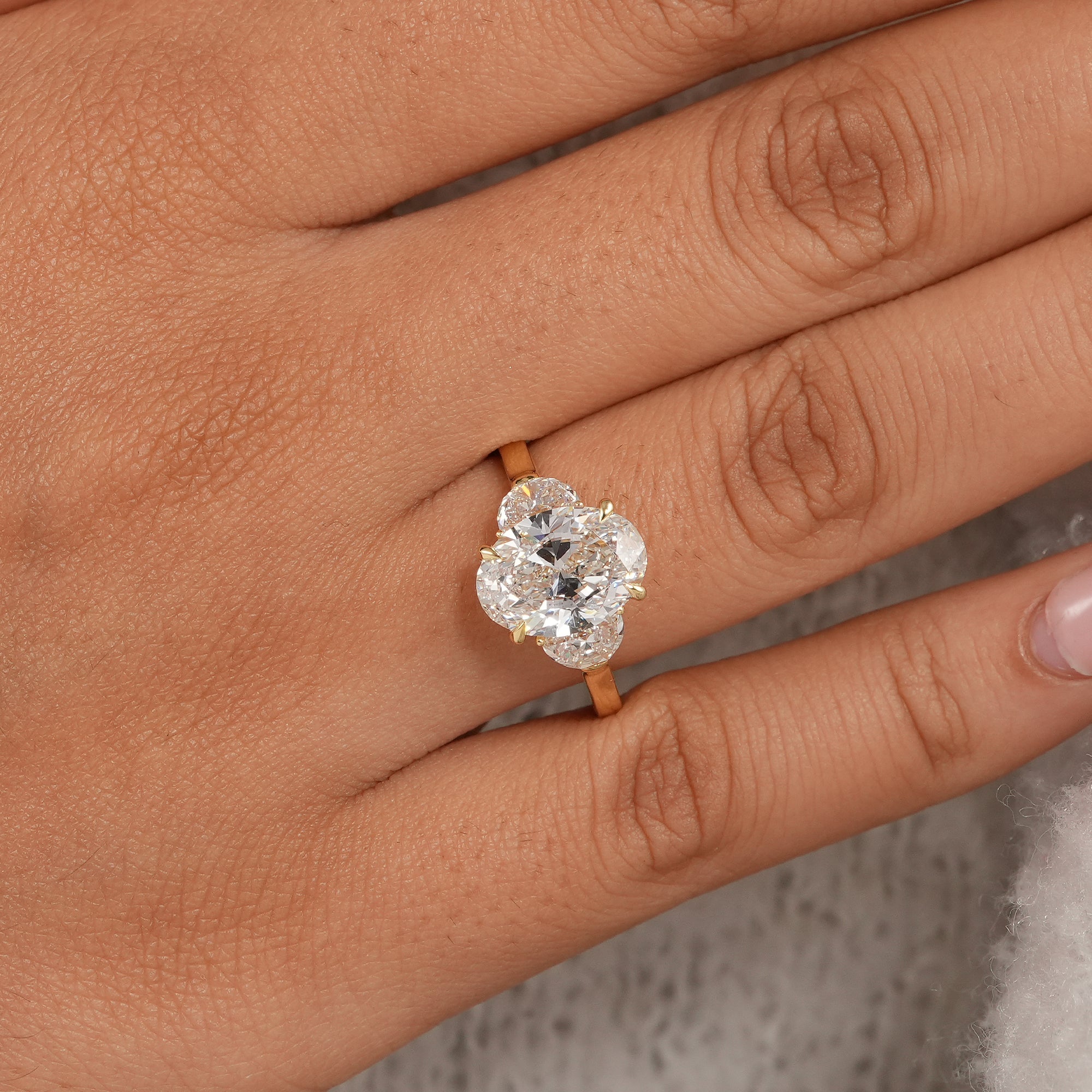 Oval diamond bridal ring with brilliant half moon accent stones in yellow gold