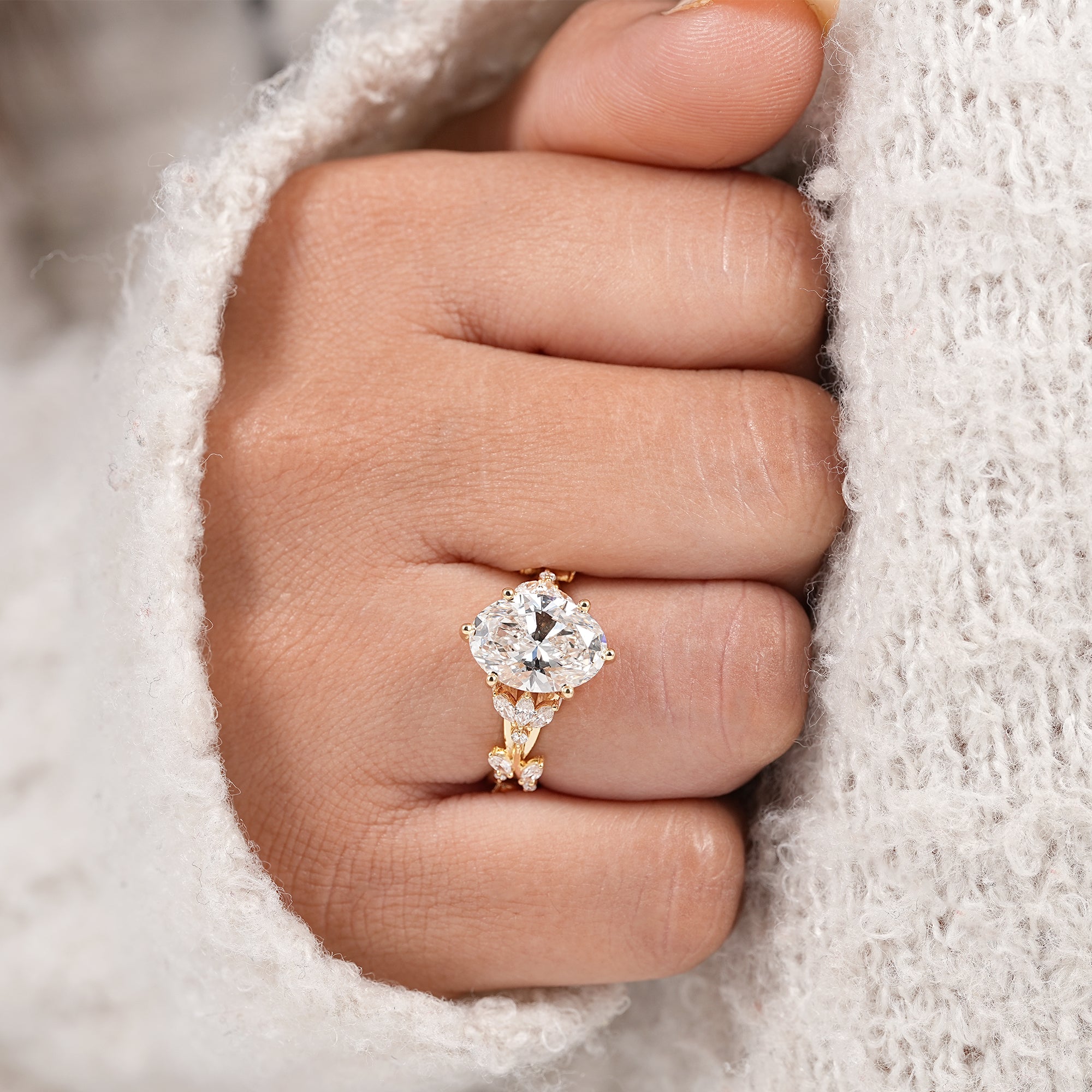Dainty nature inspired engagement ring with oval lab diamond and marquise leaf band