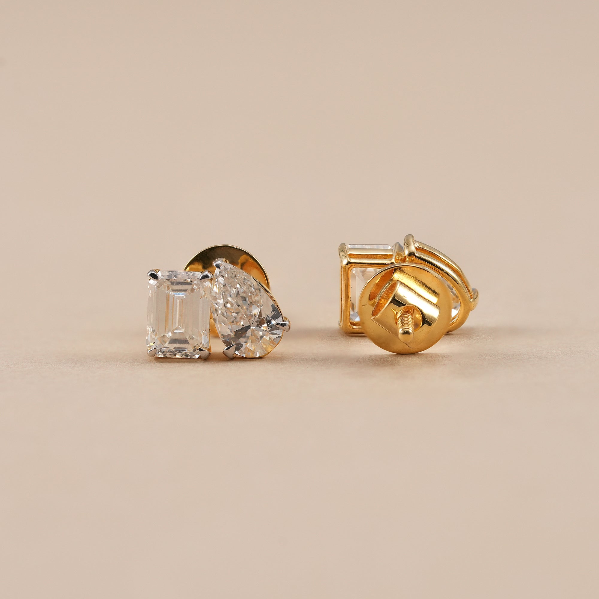 Fine jewelry emerald cut diamond and pear diamond stud earrings