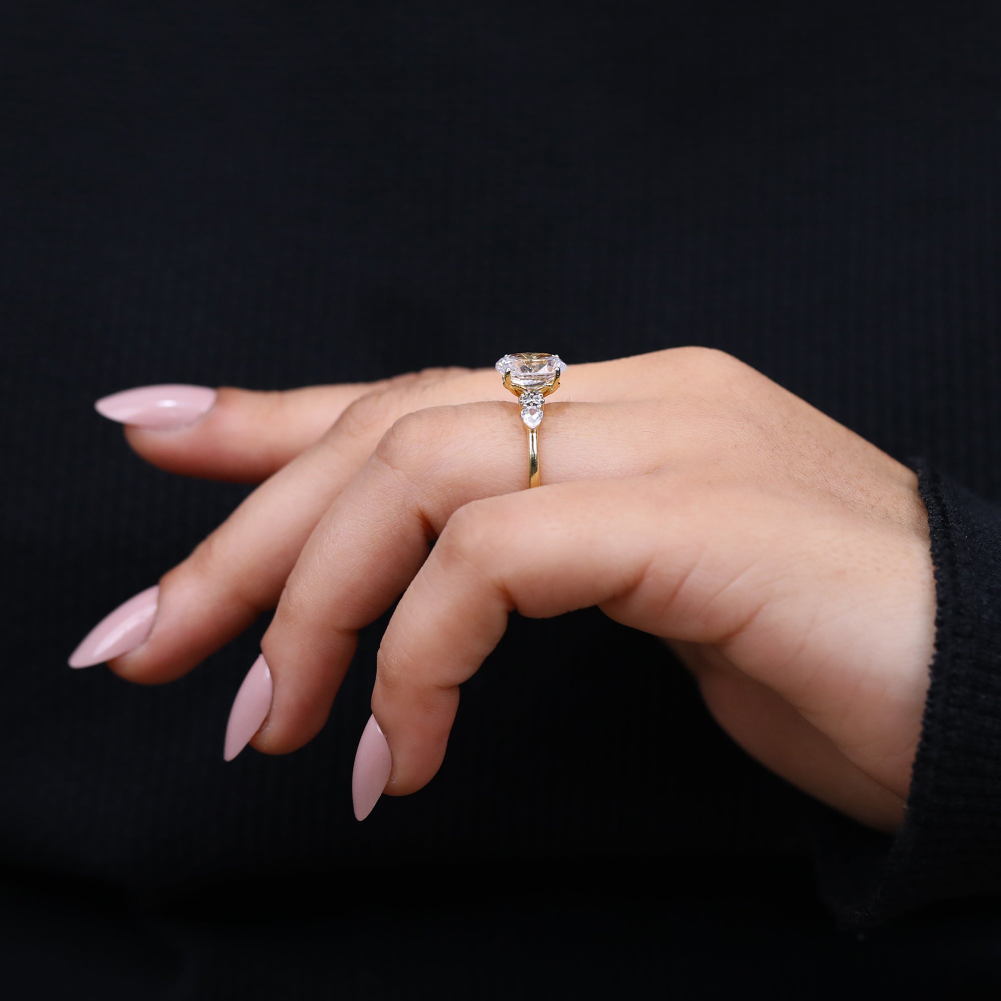 Oval lab created diamond ring with pear shaped accents