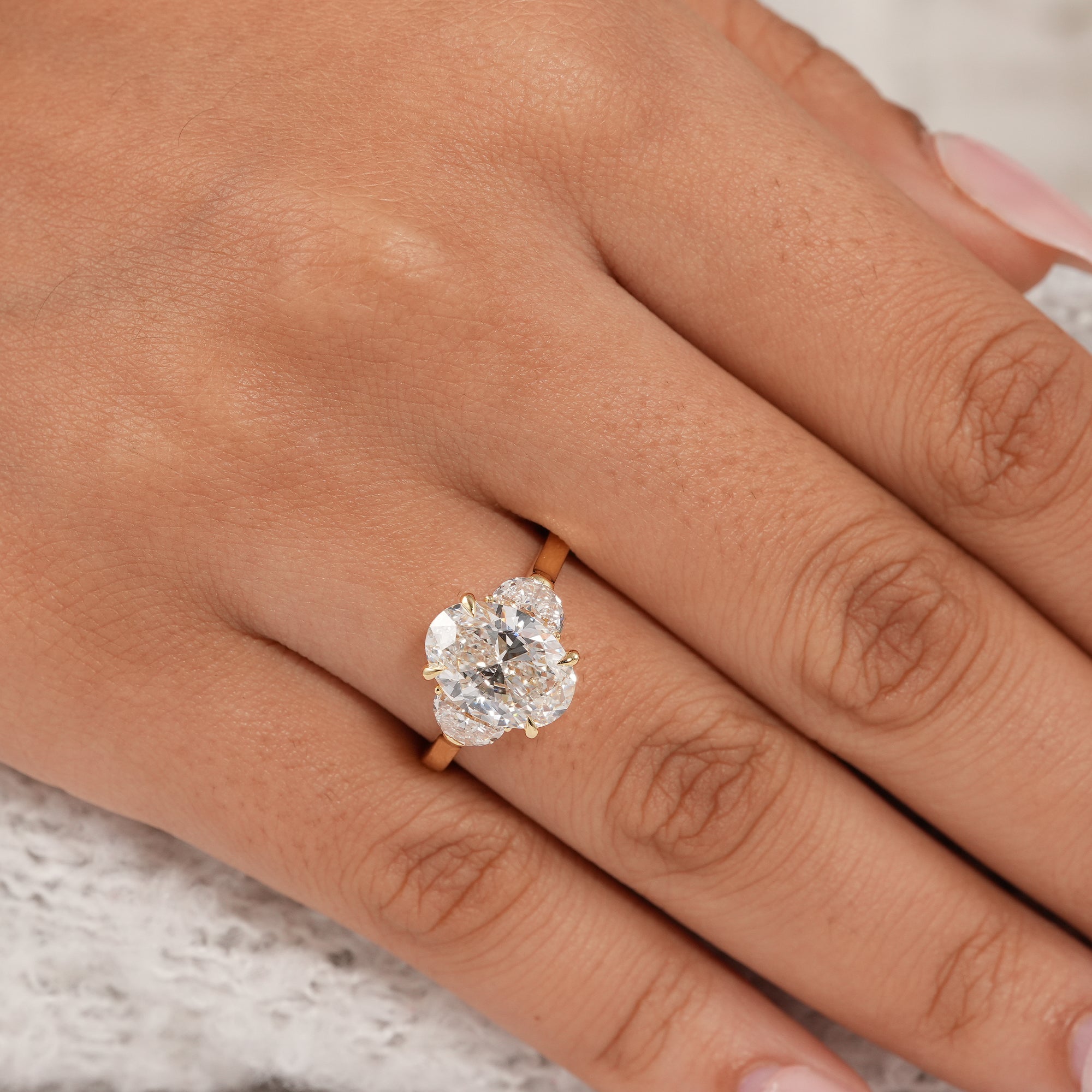Sustainable oval lab grown diamond ring with elegant half moon side diamonds