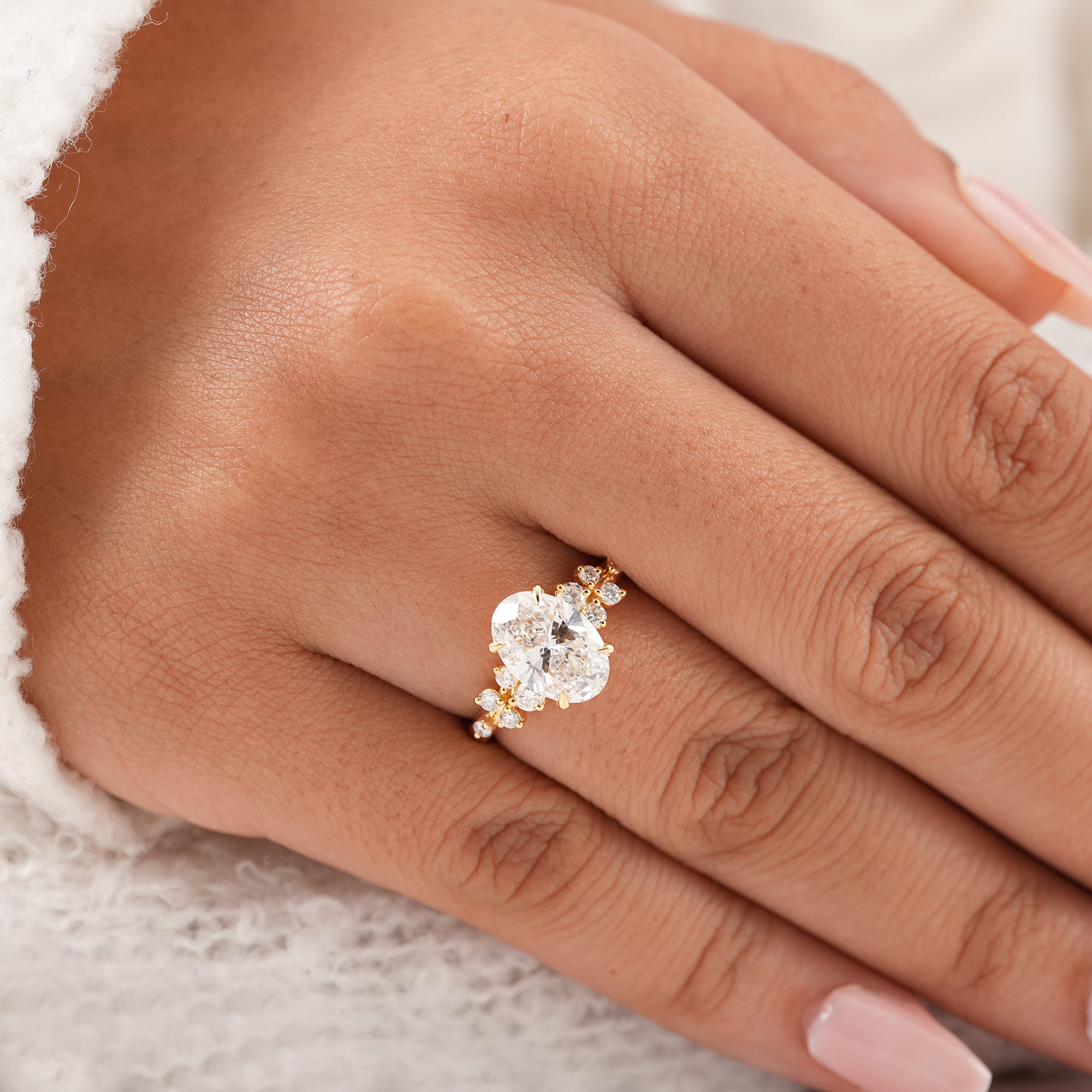 Luxury oval engagement ring featuring floral diamond cluster band