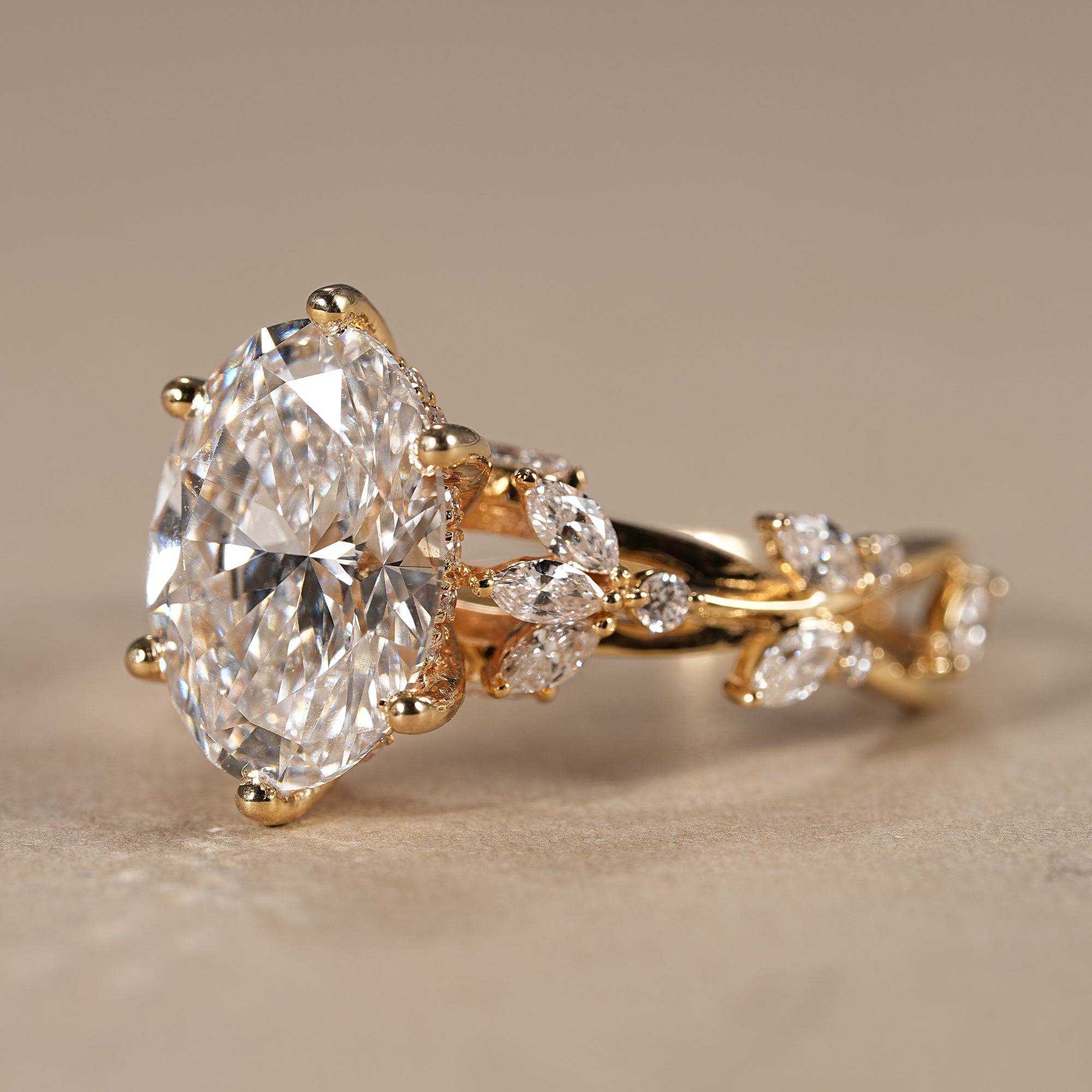 Botanical oval cut engagement ring with marquise leaf diamonds and twisted gold setting