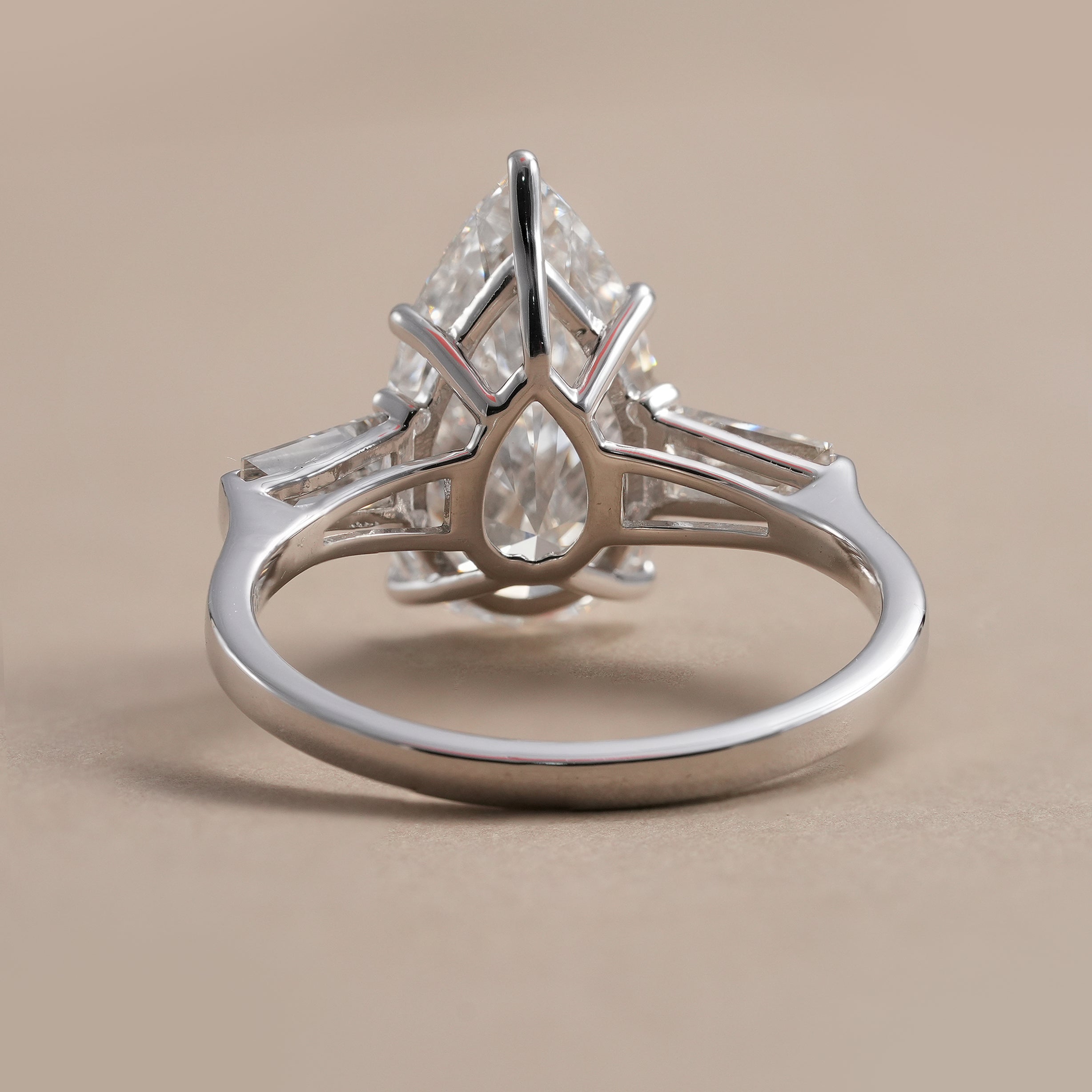 Pear diamond engagement ring with baguette side stones close up
