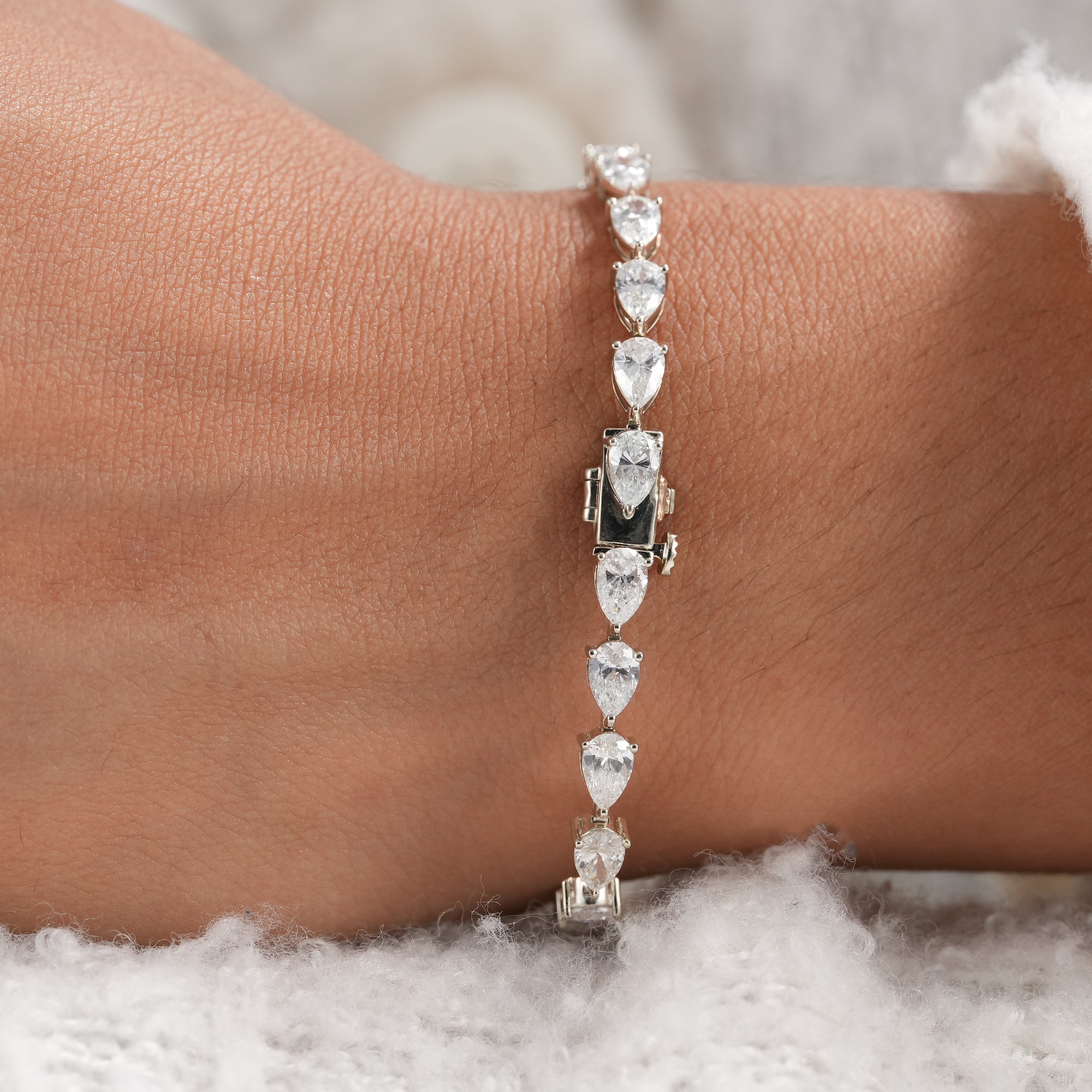 Anniversary pear diamond bracelet with secure box clasp.