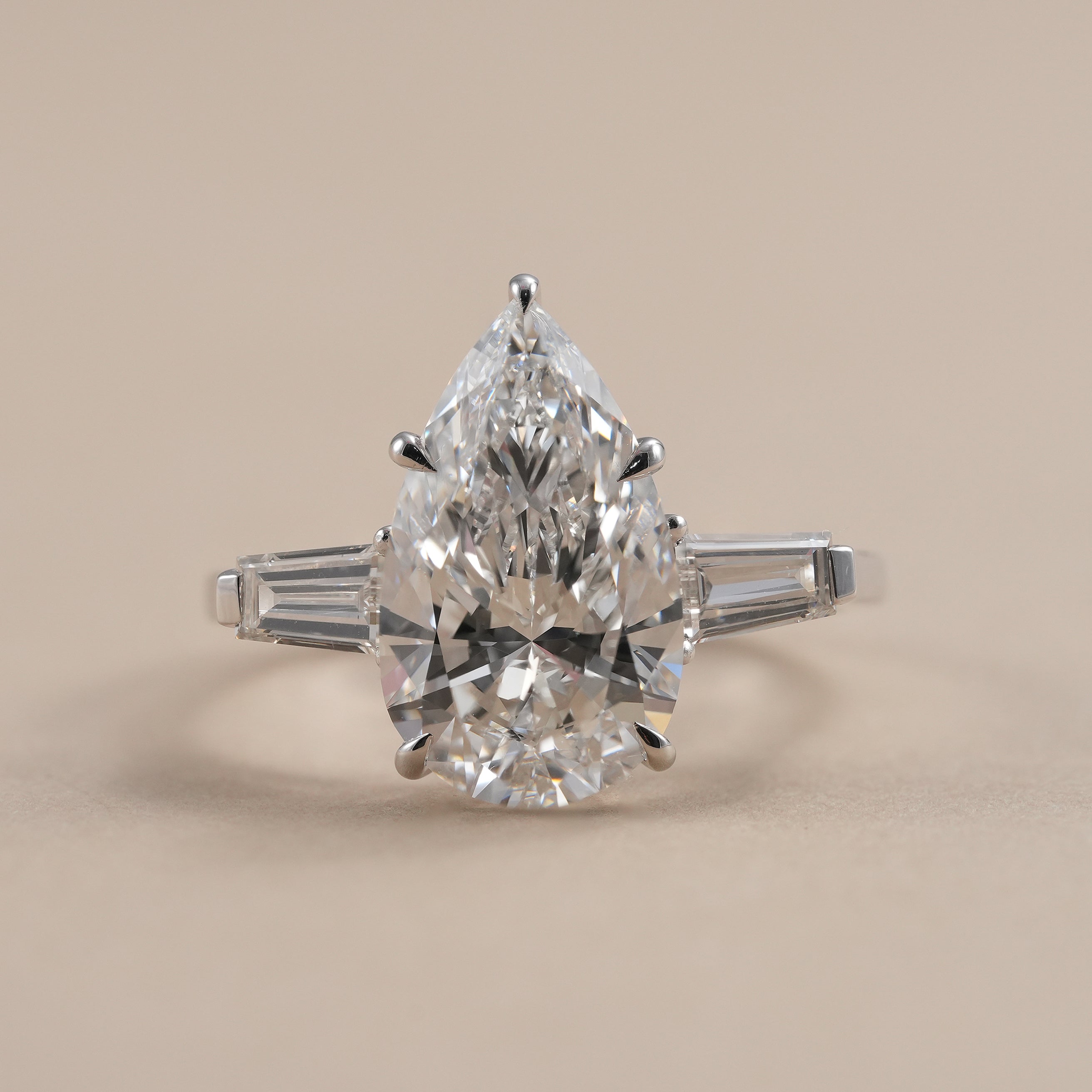 Pear lab grown diamond three stone engagement ring with baguette side stones