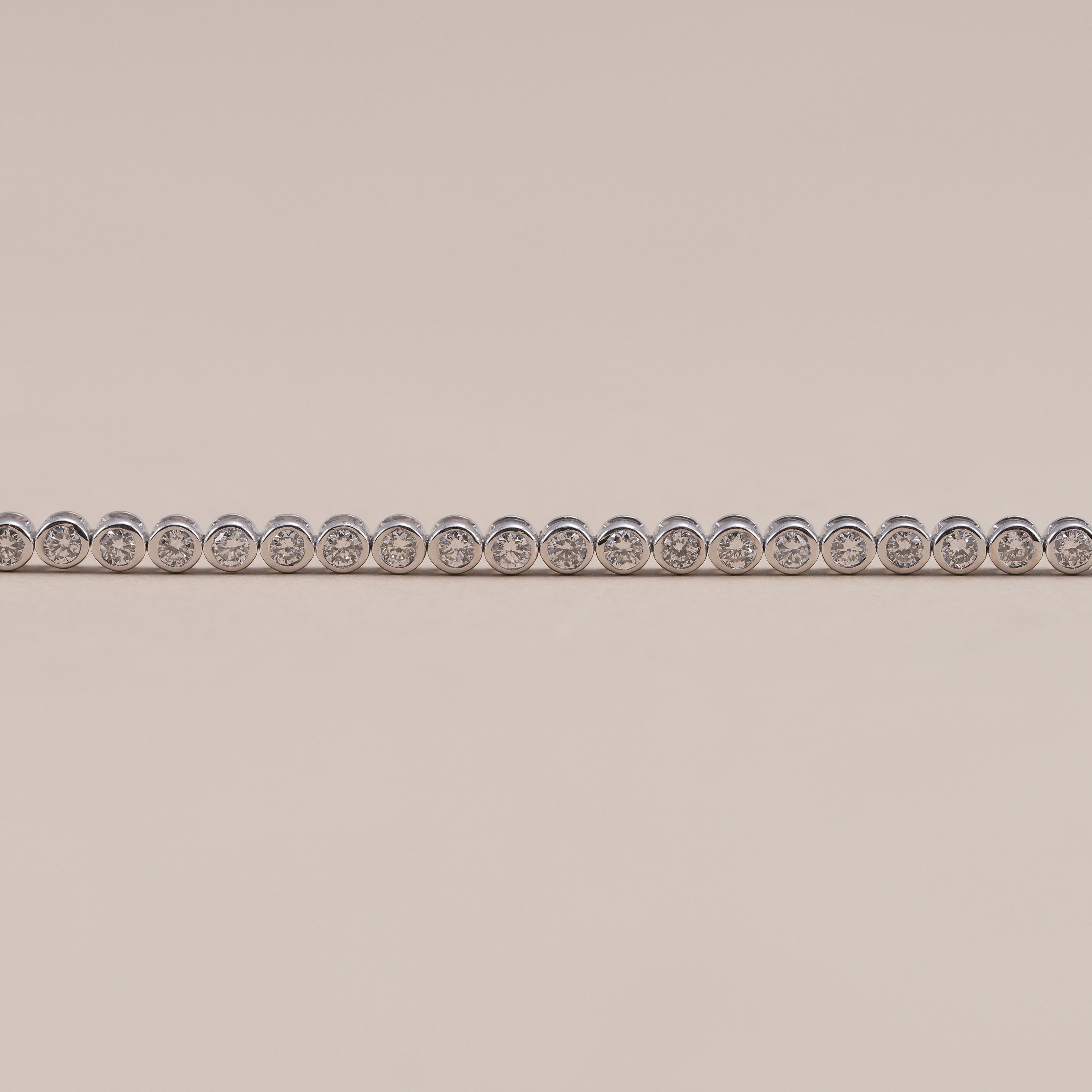 Elegant 2.5mm bezel set diamond tennis bracelet for women.