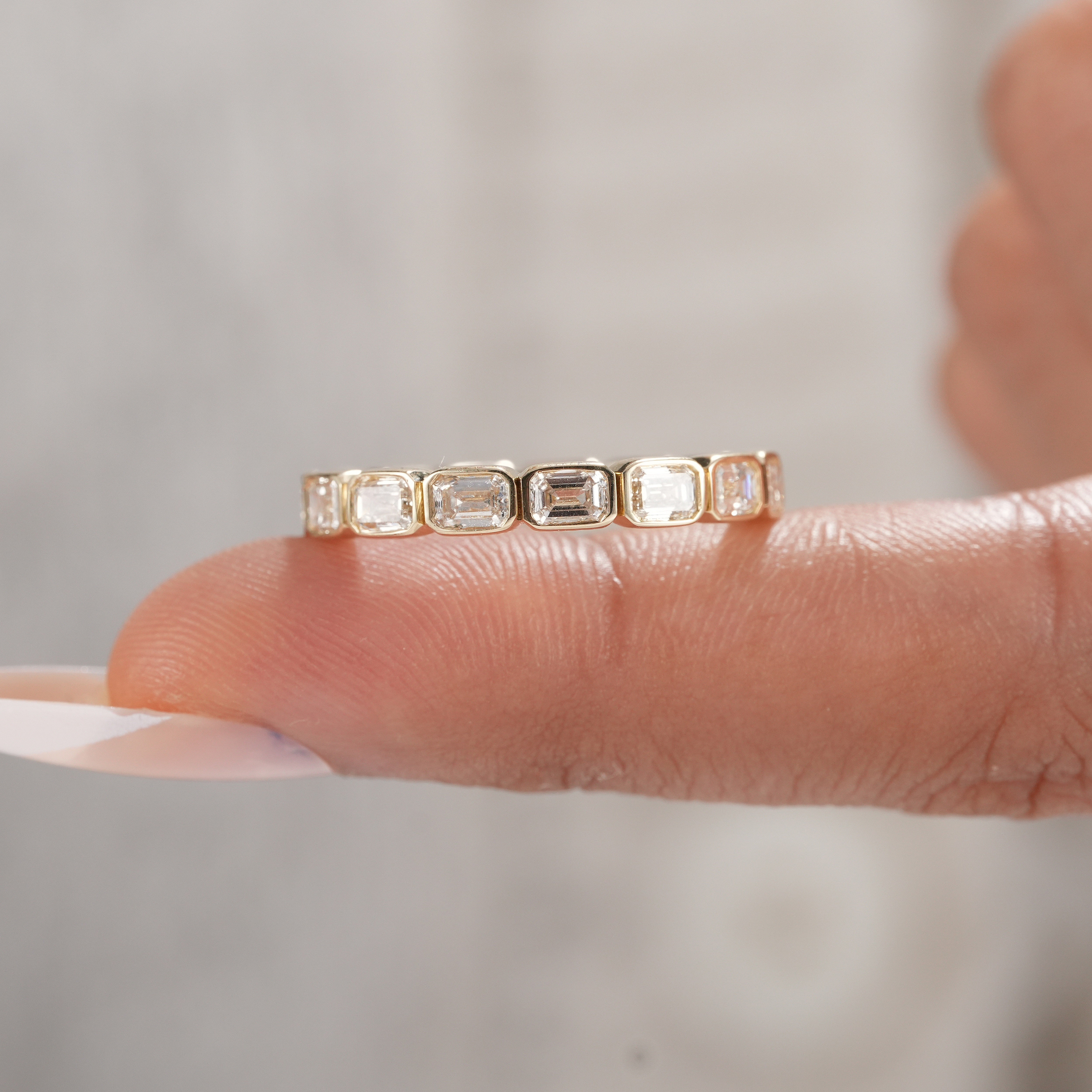 Handmade bezel set emerald diamond wedding band.