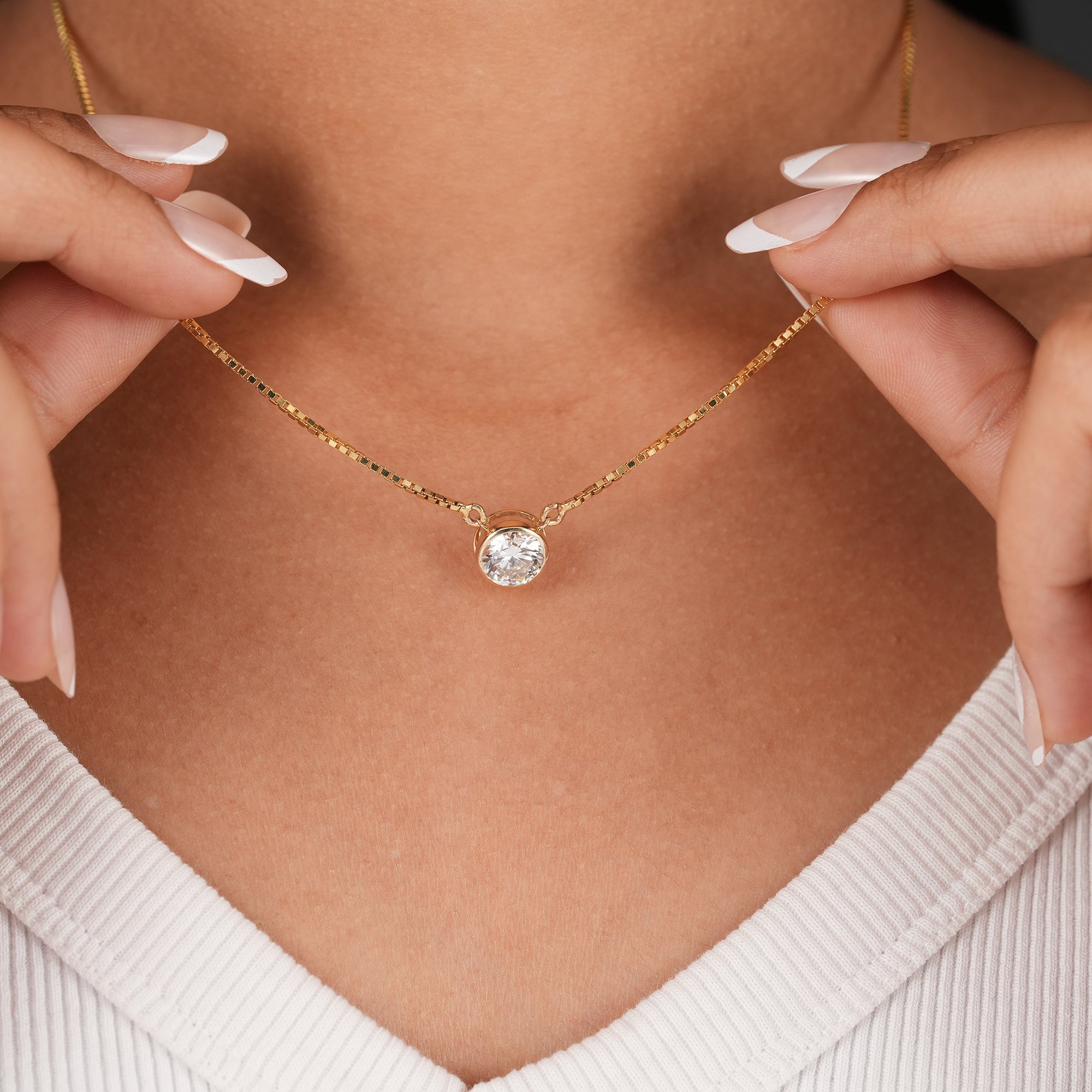 Bezel set round cut diamond pendant on gold chain