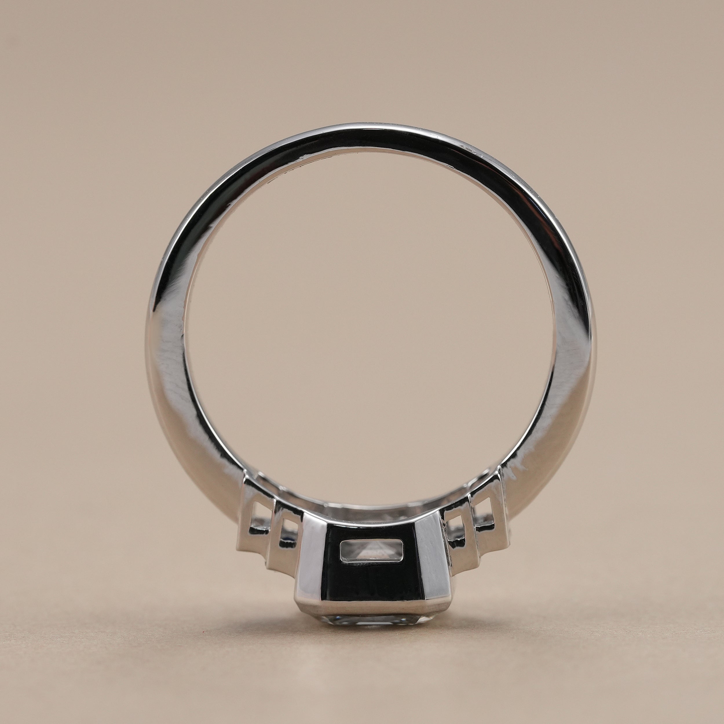 Art Deco diamond engagement ring featuring blue sapphire baguette accents.
