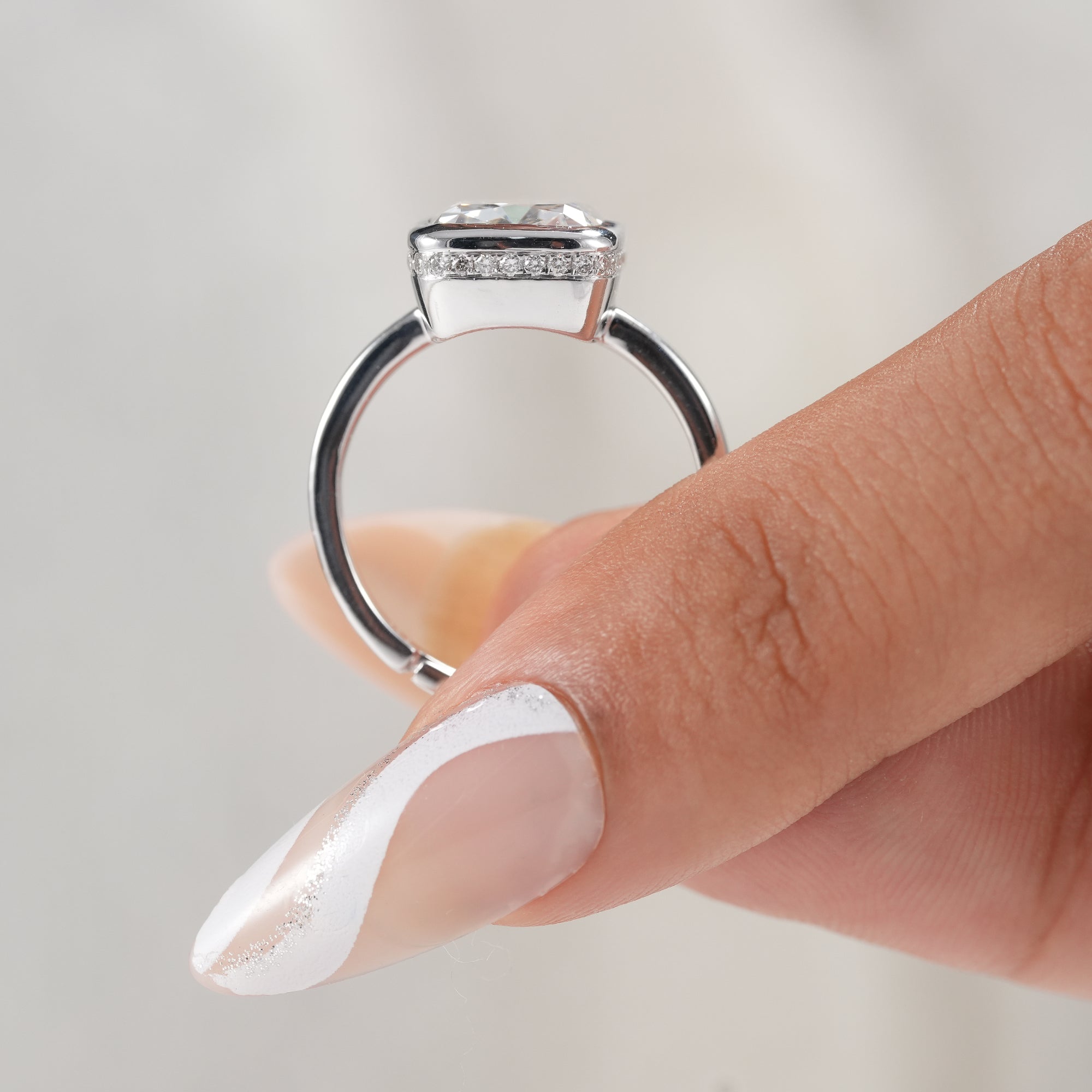 Handcrafted cushion diamond ring with polished white gold band.