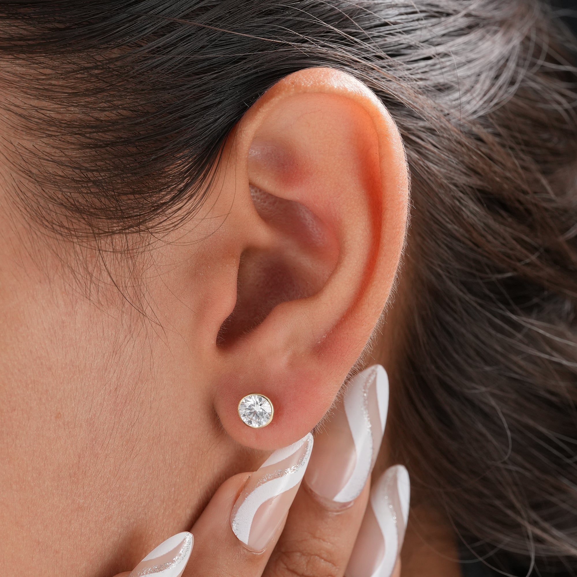 Minimalist round diamond earrings for everyday wear.