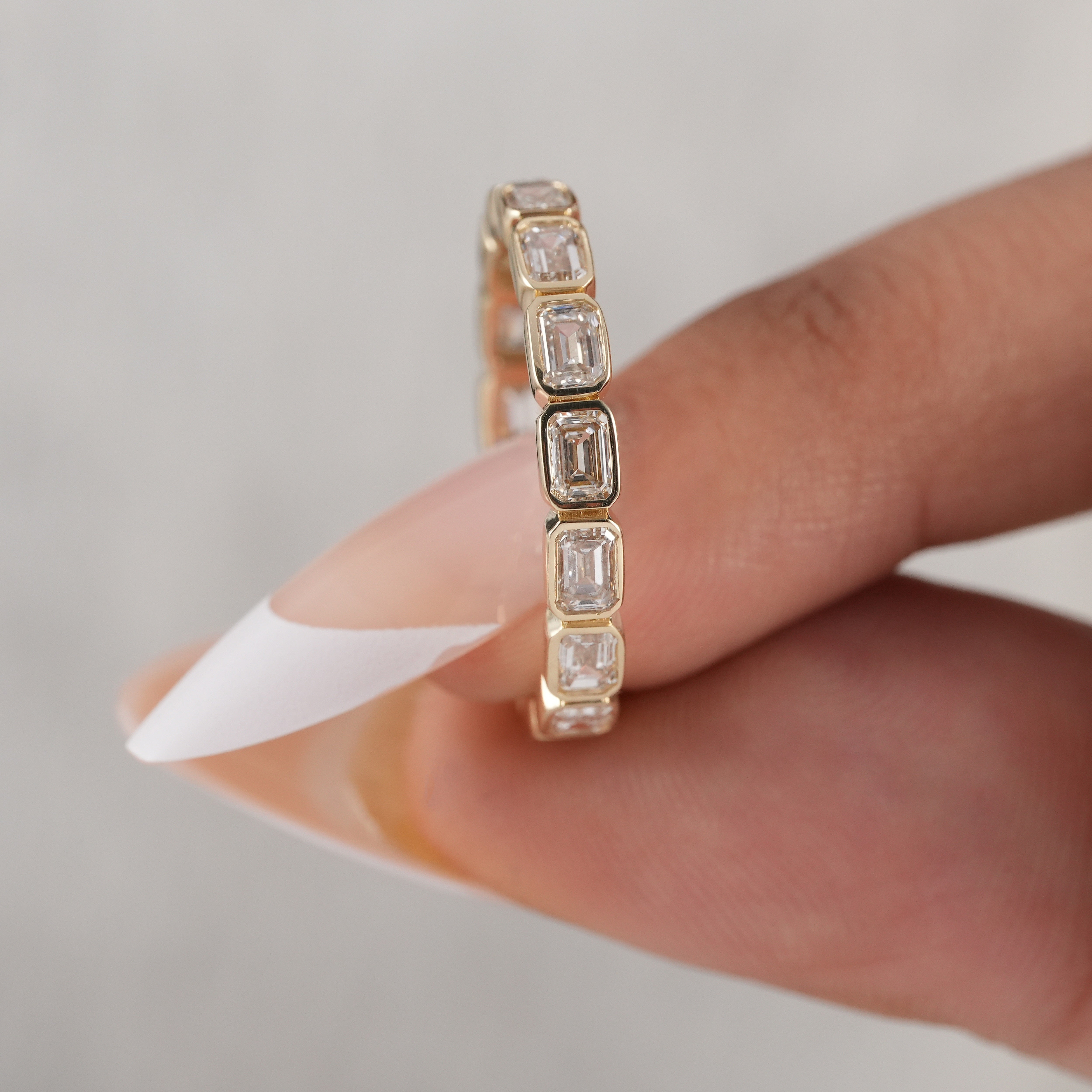 Full bezel set emerald diamond bridal band.
