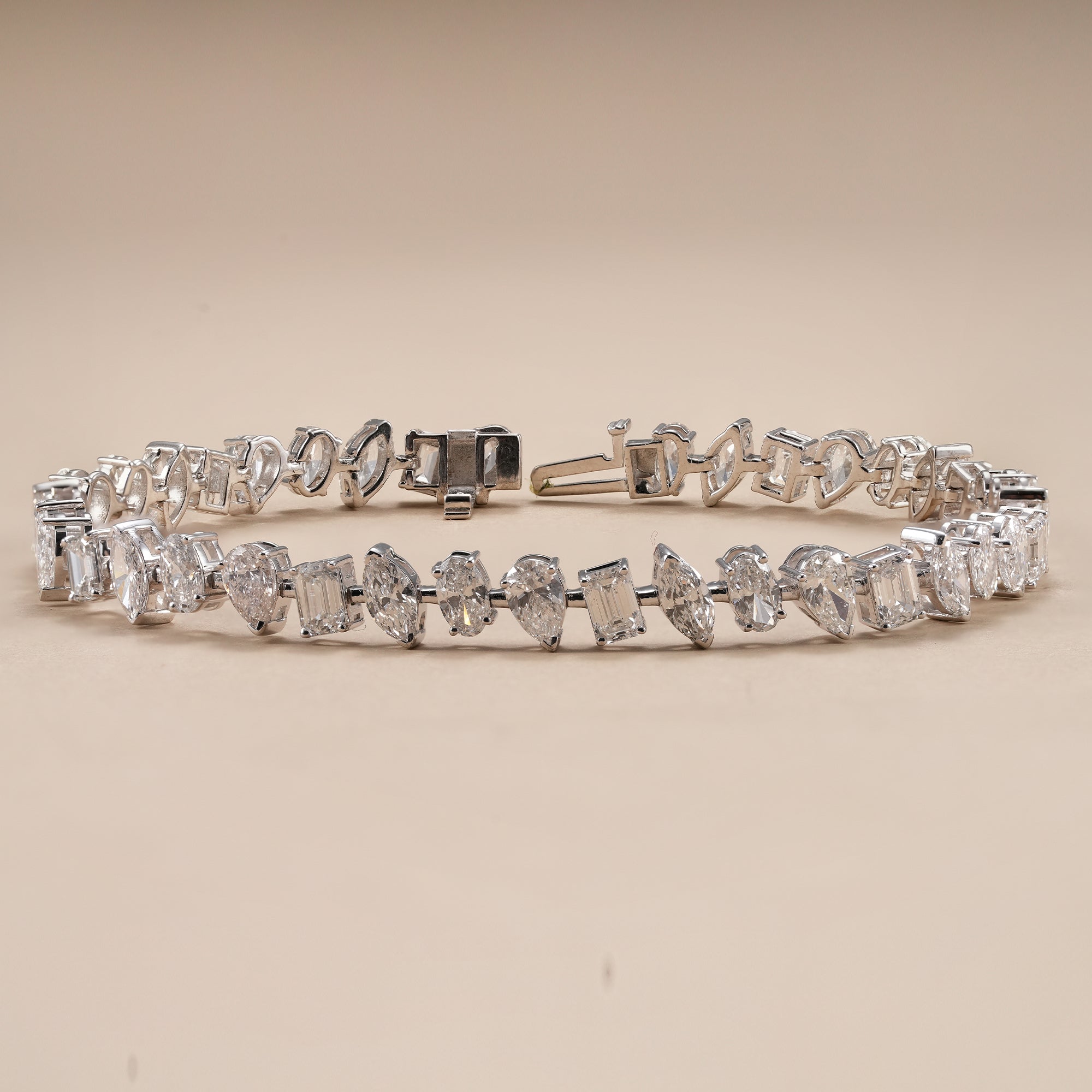 Premium mixed shape diamond tennis bracelet with secure box clasp.