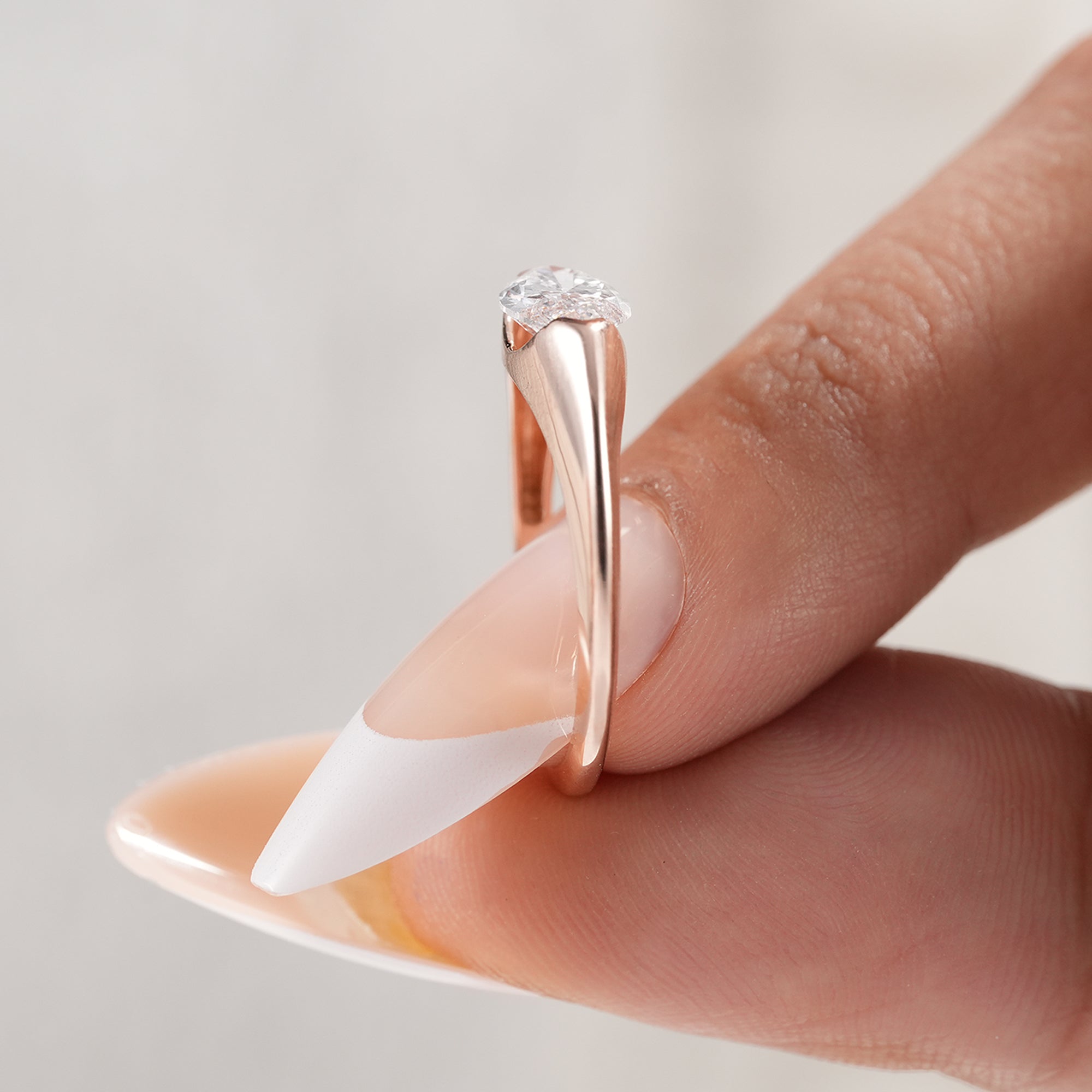 Handmade marquise solitaire engagement ring with sleek band.