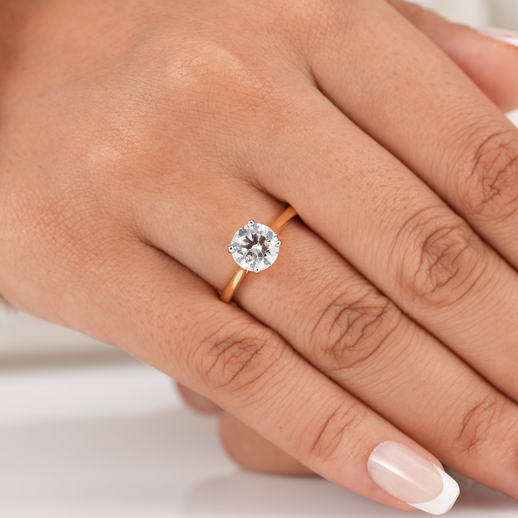 Minimalist round diamond engagement ring in yellow gold