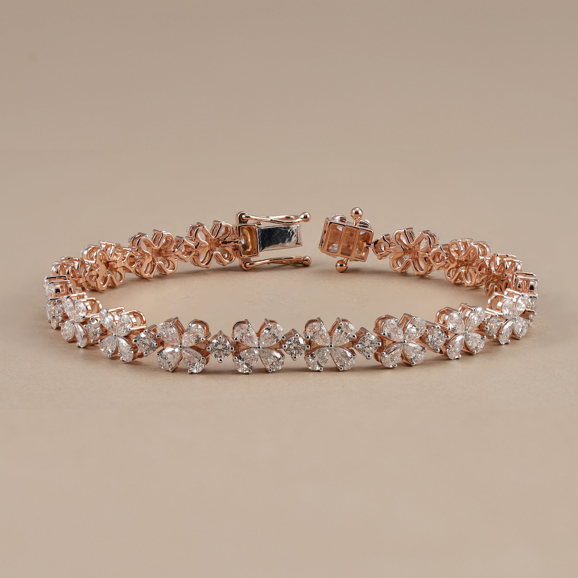 Floral diamond tennis bracelet featuring pear shaped diamond petals