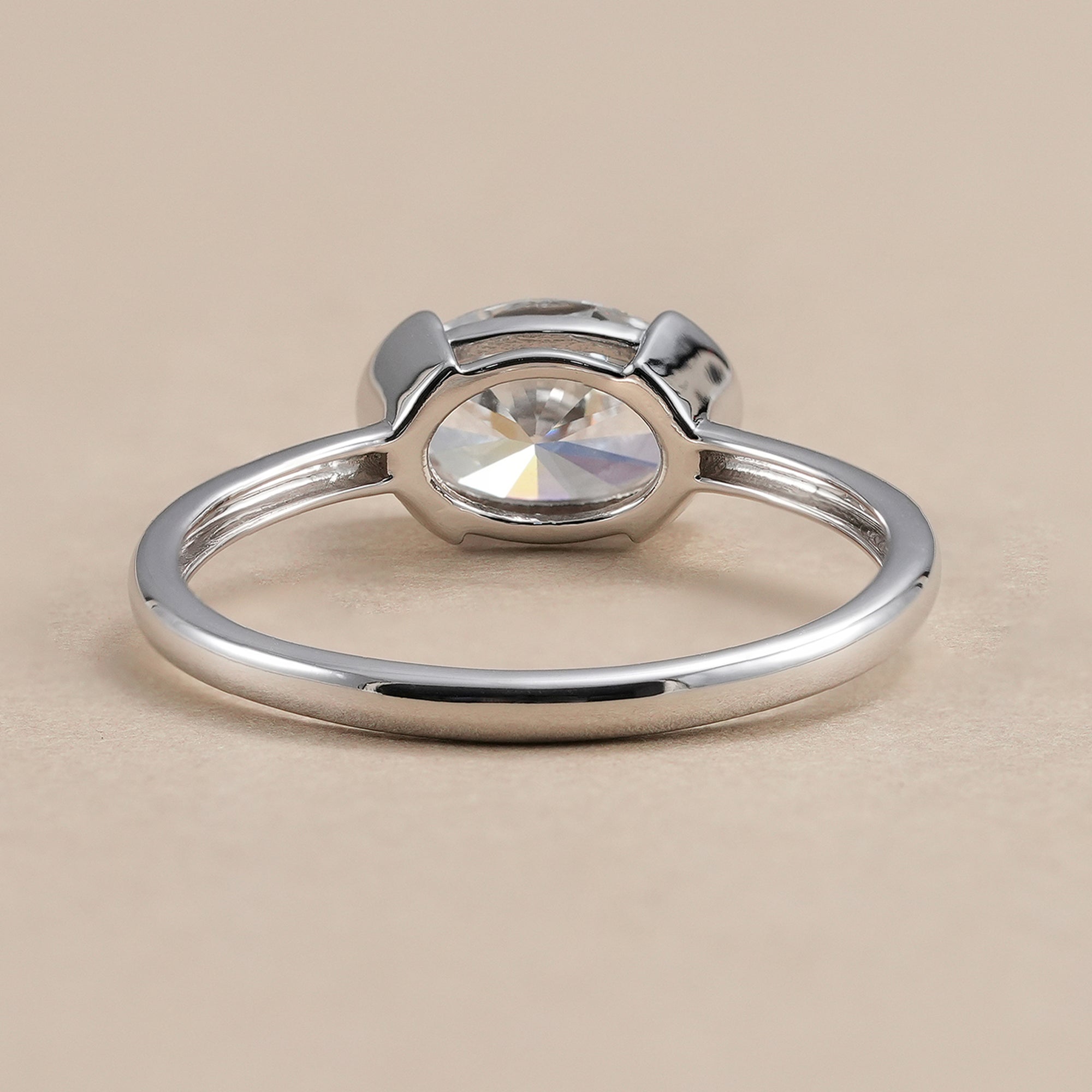 Oval lab diamond engagement ring in half bezel setting