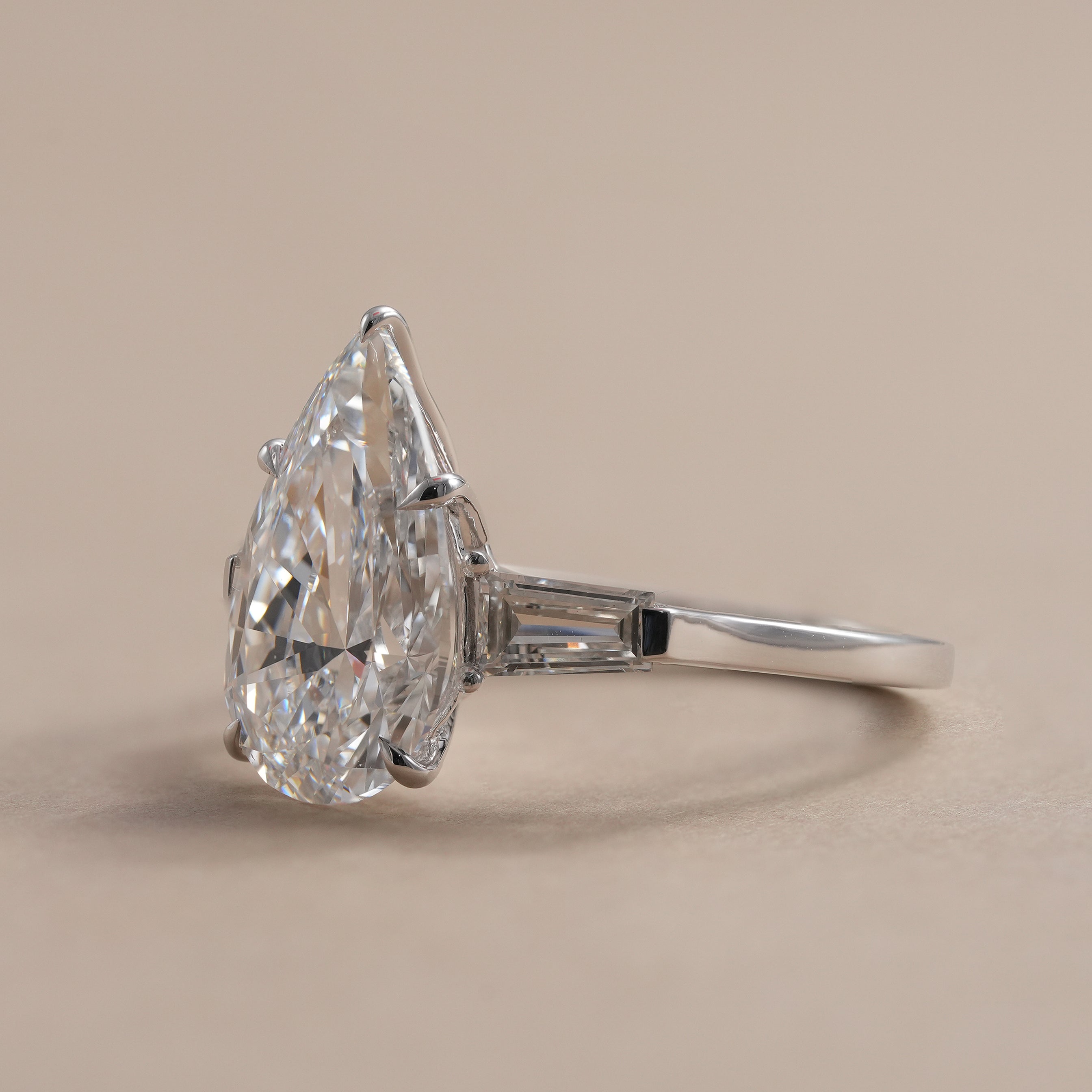 Pear lab diamond engagement ring with tapered baguette diamonds