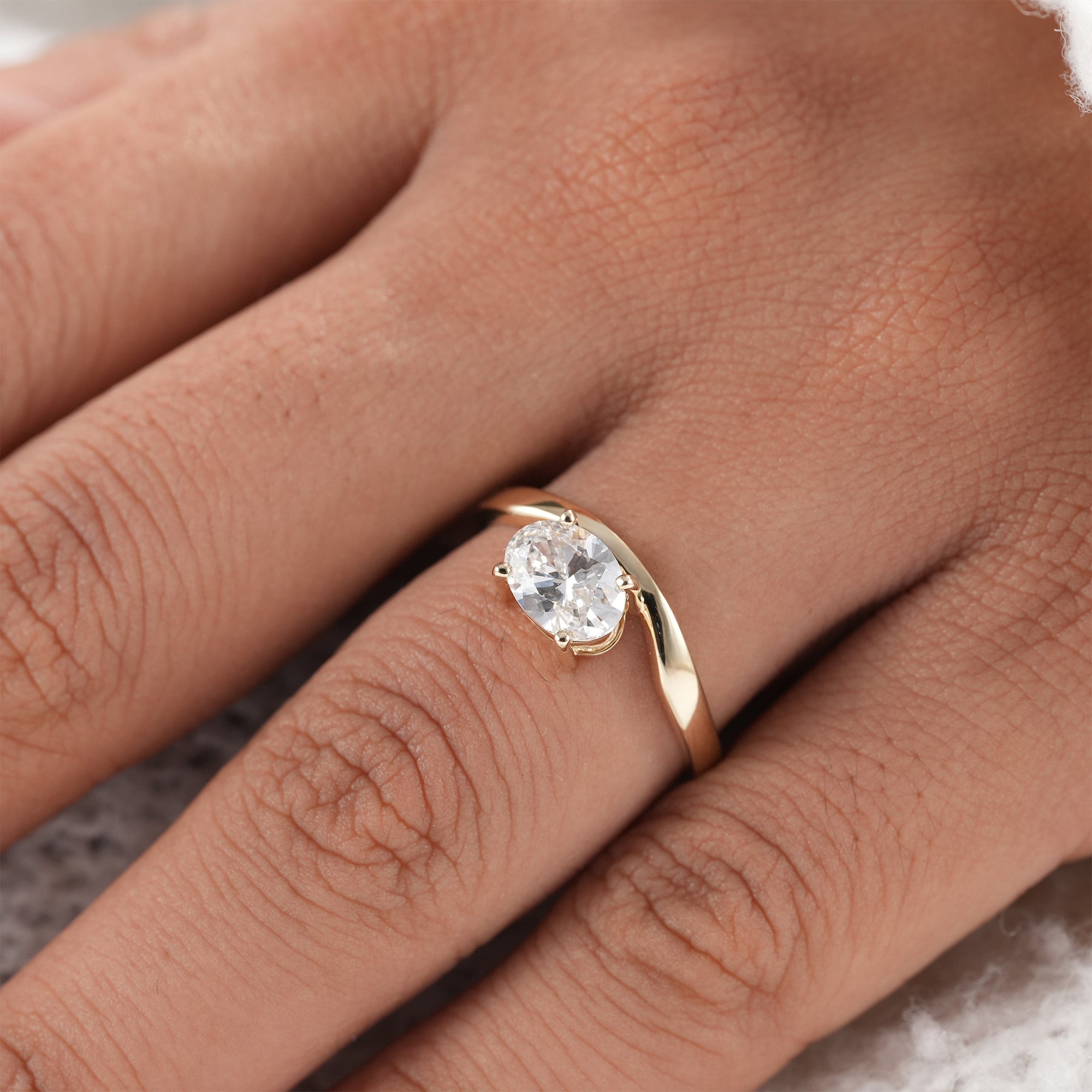 Modern oval engagement ring with soft V shank.