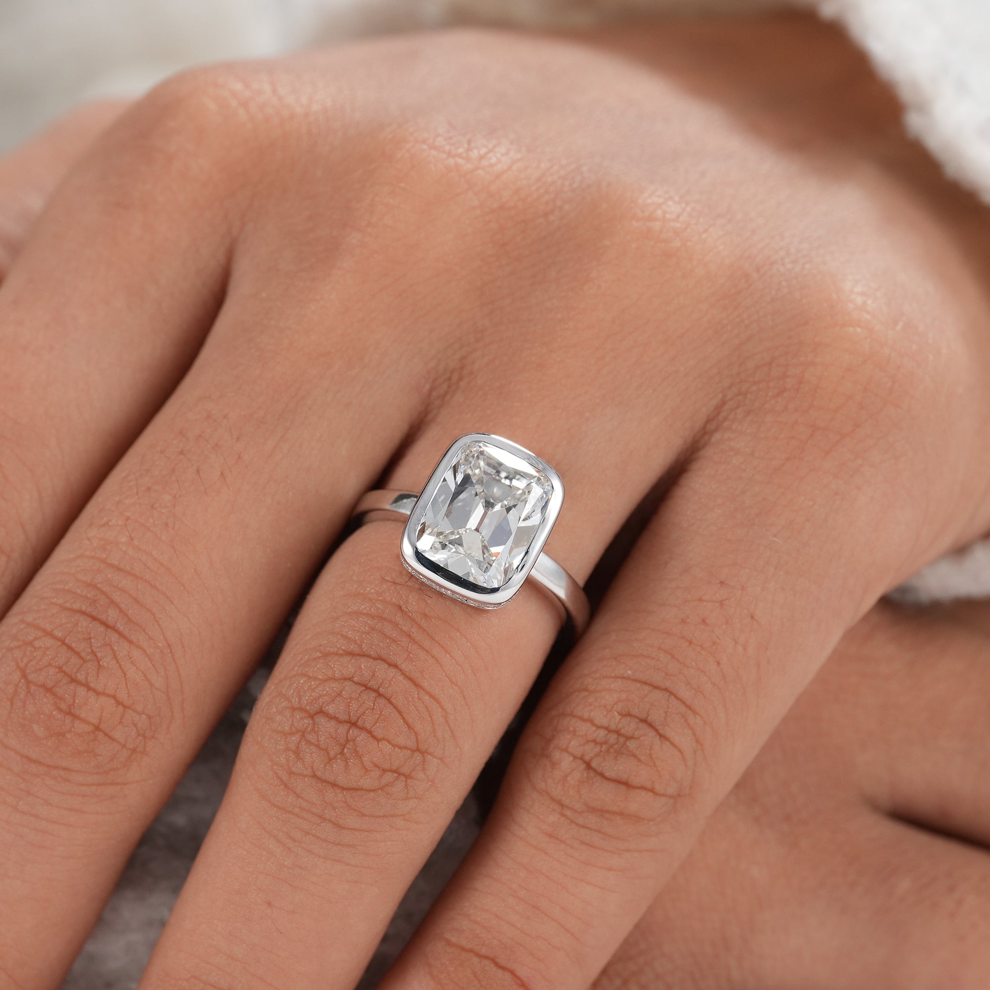 Handcrafted cushion diamond ring with polished white gold band.