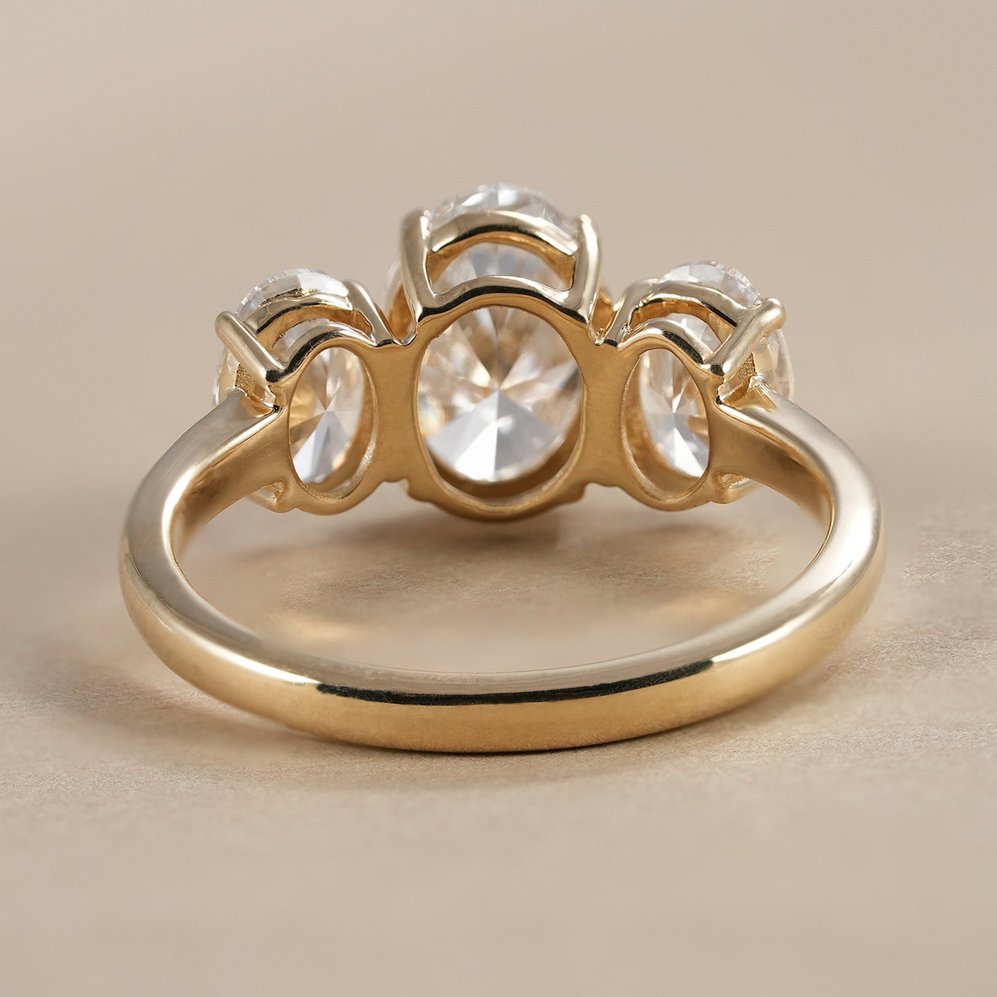 Oval engagement ring featuring three brilliant diamonds