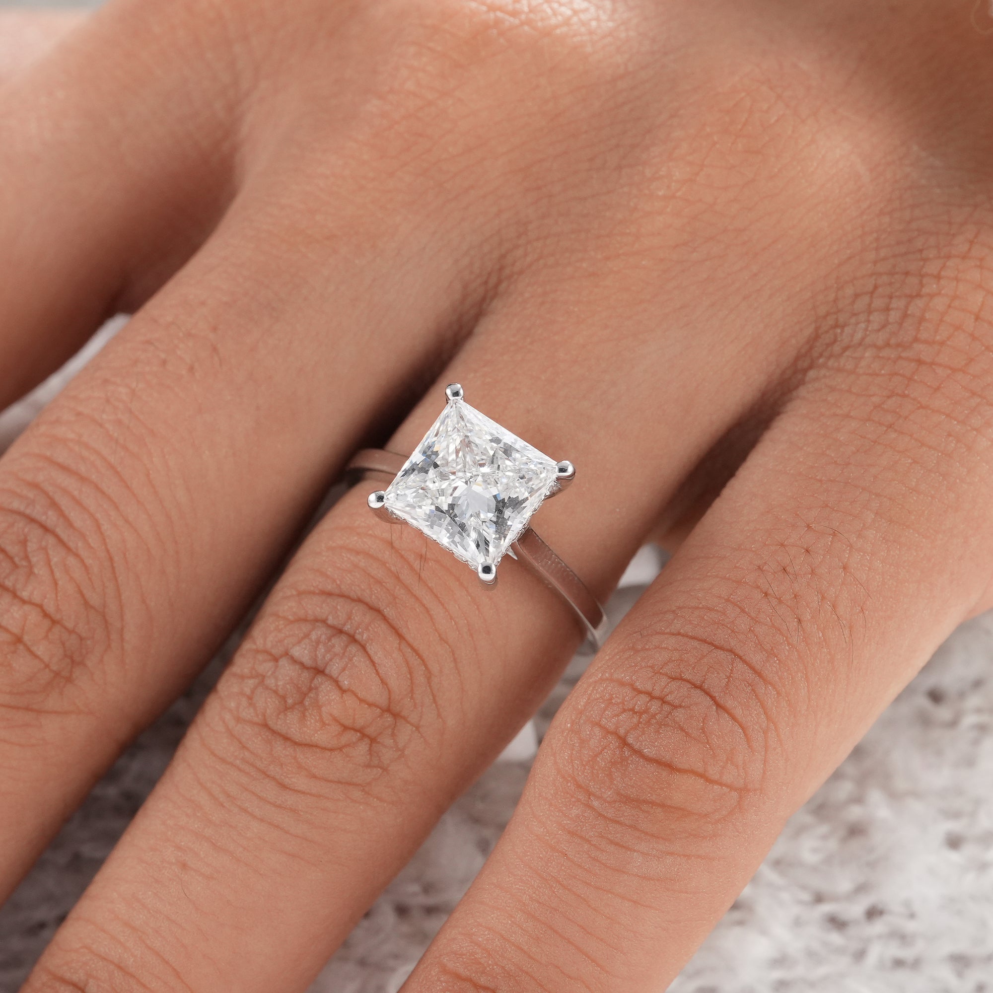 IGI certified princess diamond engagement ring with polished white gold band.