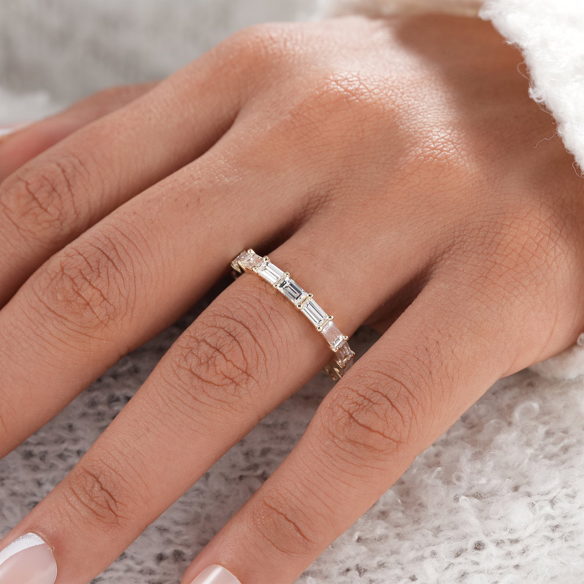 Fine jewelry baguette diamond ring in yellow gold.