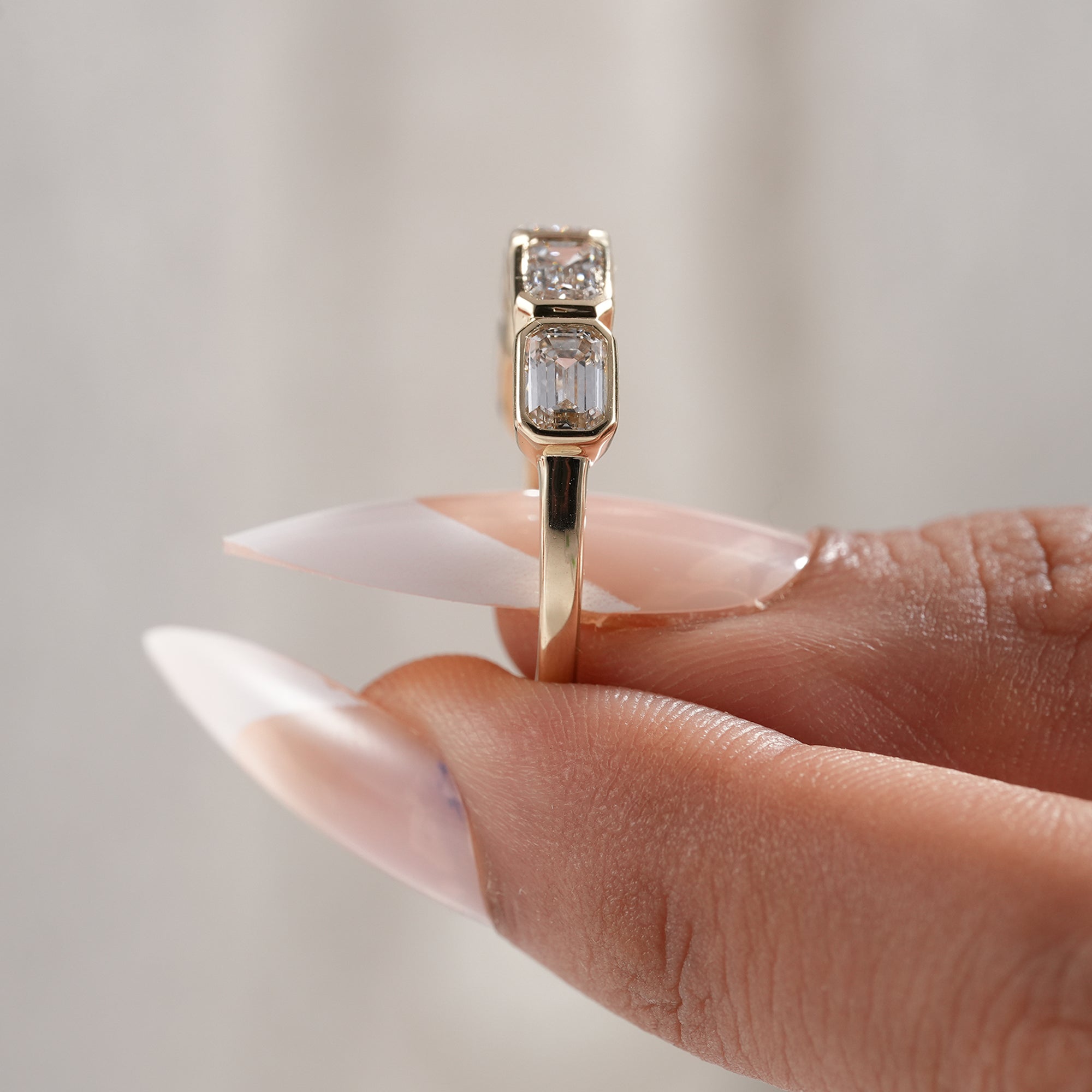 Emerald cut bezel wedding band handcrafted in gold.