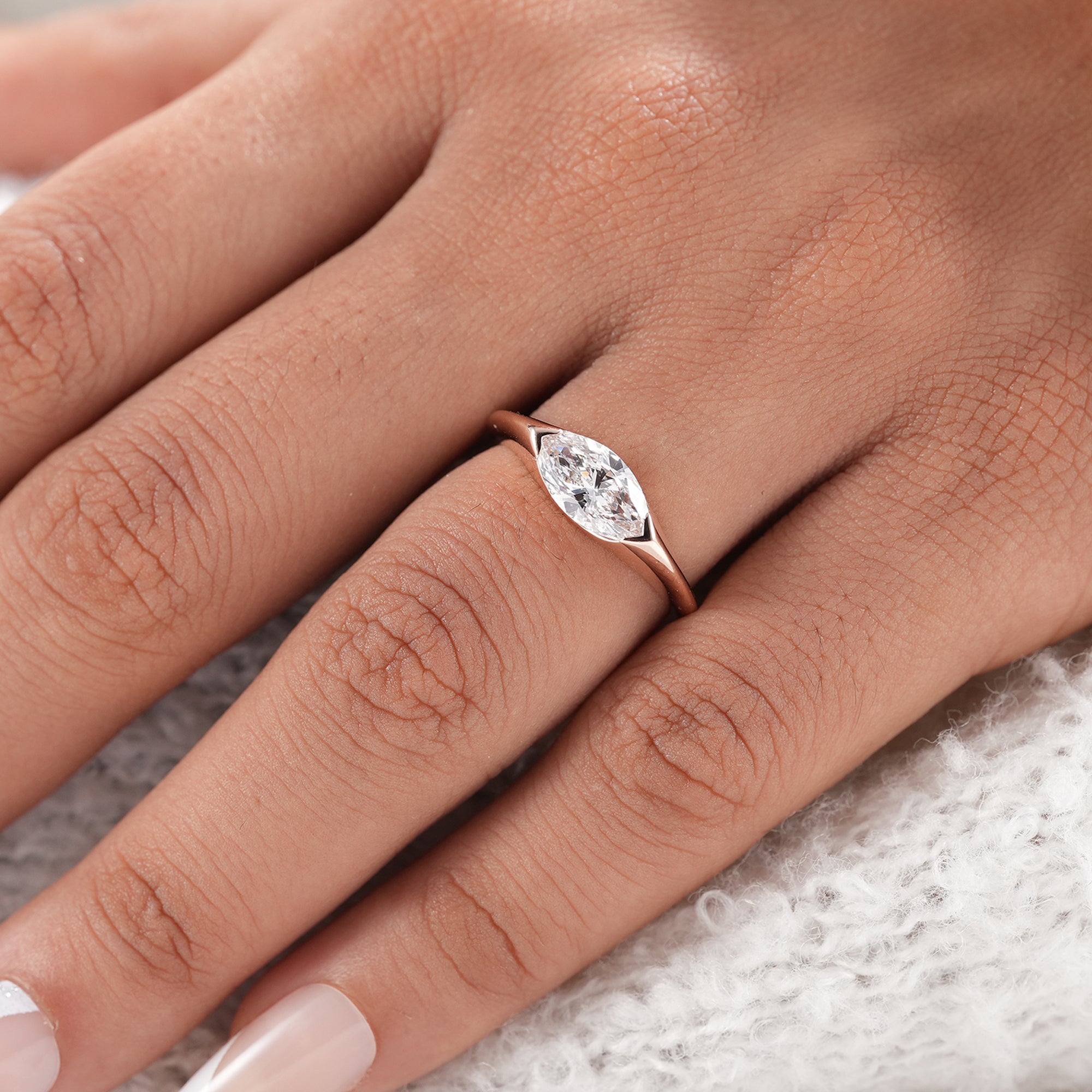 Sustainable marquise diamond ring in polished rose gold.
