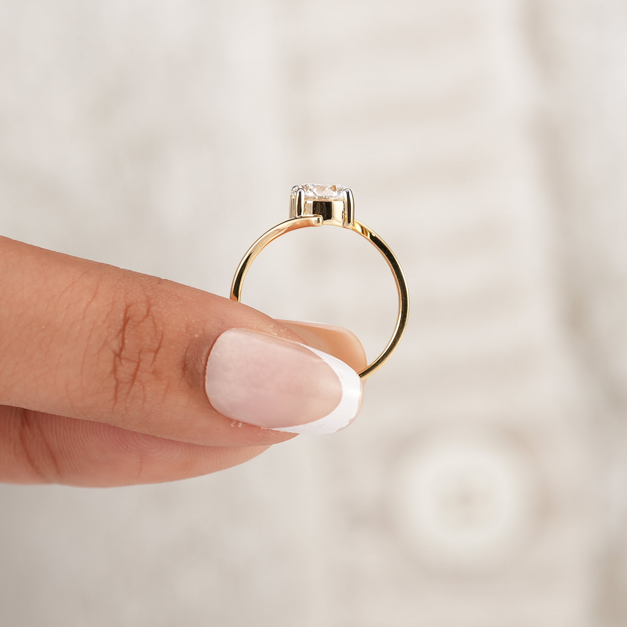 Solid gold round solitaire bypass ring with modern design