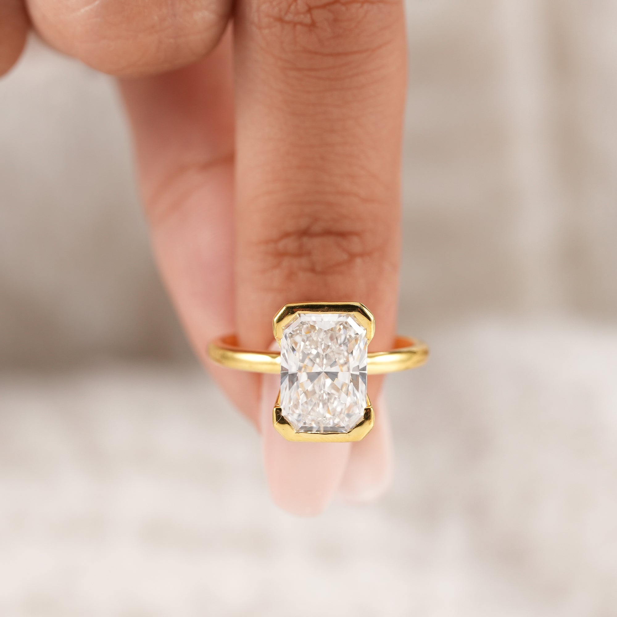 Premium radiant lab diamond engagement ring with secure bezel mount.