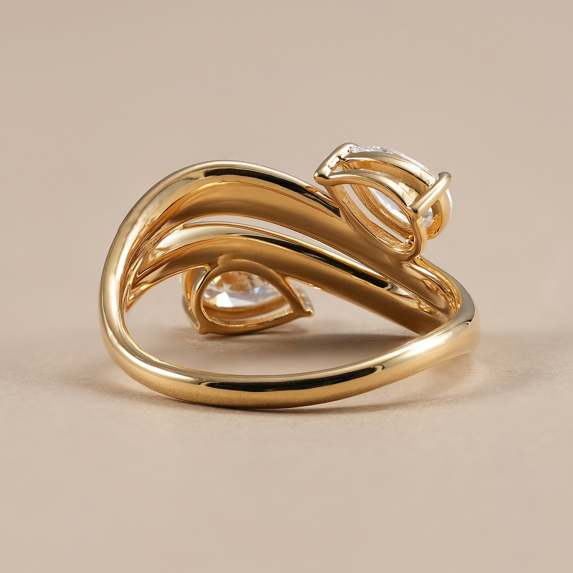 Handcrafted pear lab grown diamond ring with modern open crossover design