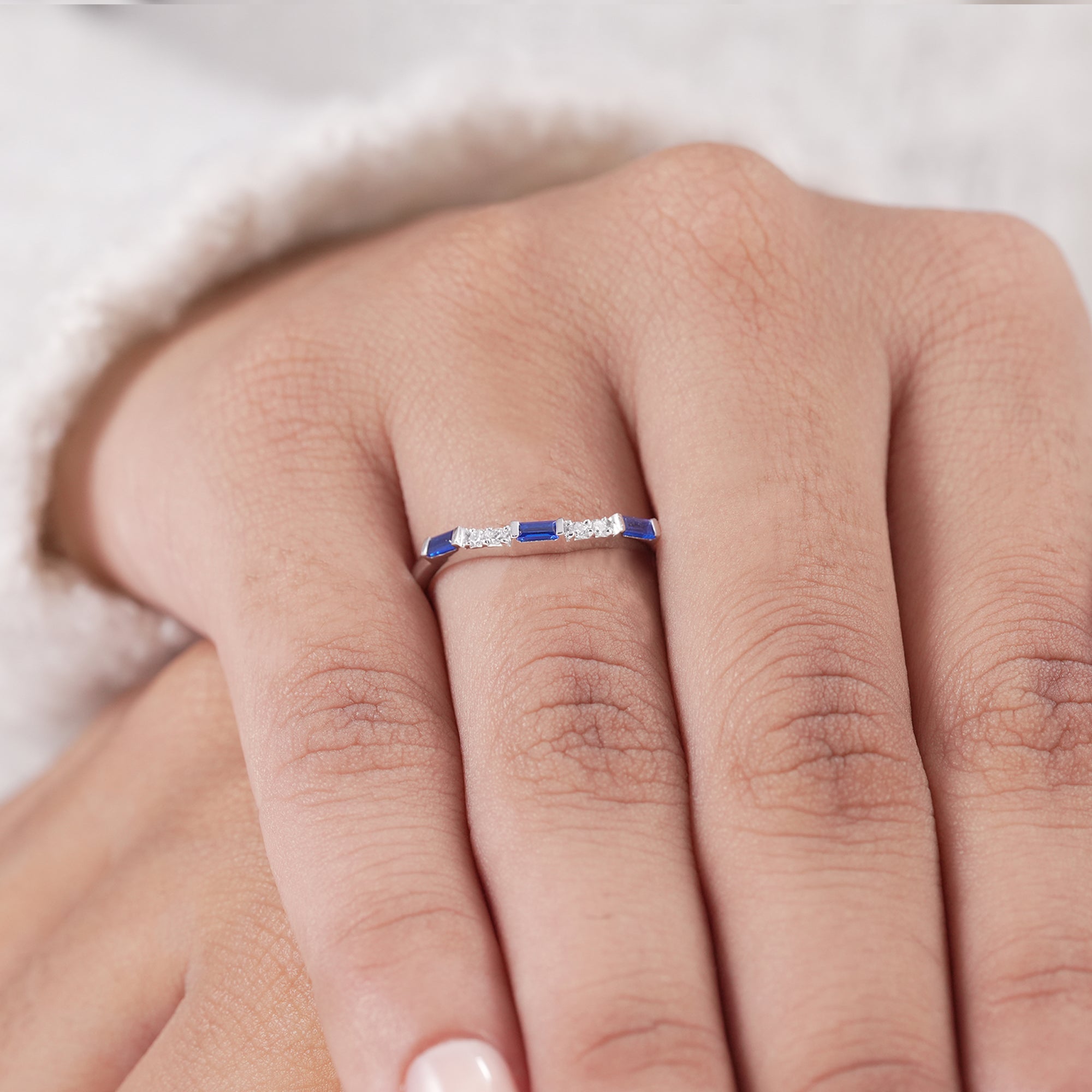 Fine jewelry curved ring with blue baguette accents